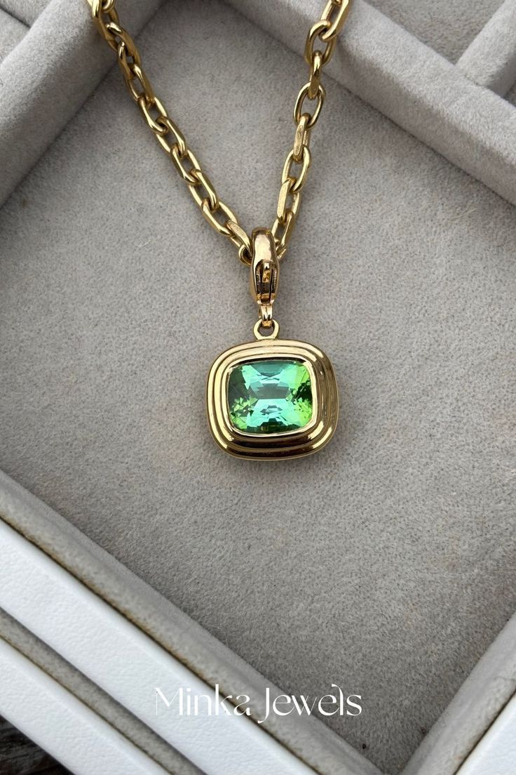 Close-up lifestyle image of 5.35ct green tourmaline pendant in Athena 18k yellow gold step setting by Minka Jewels