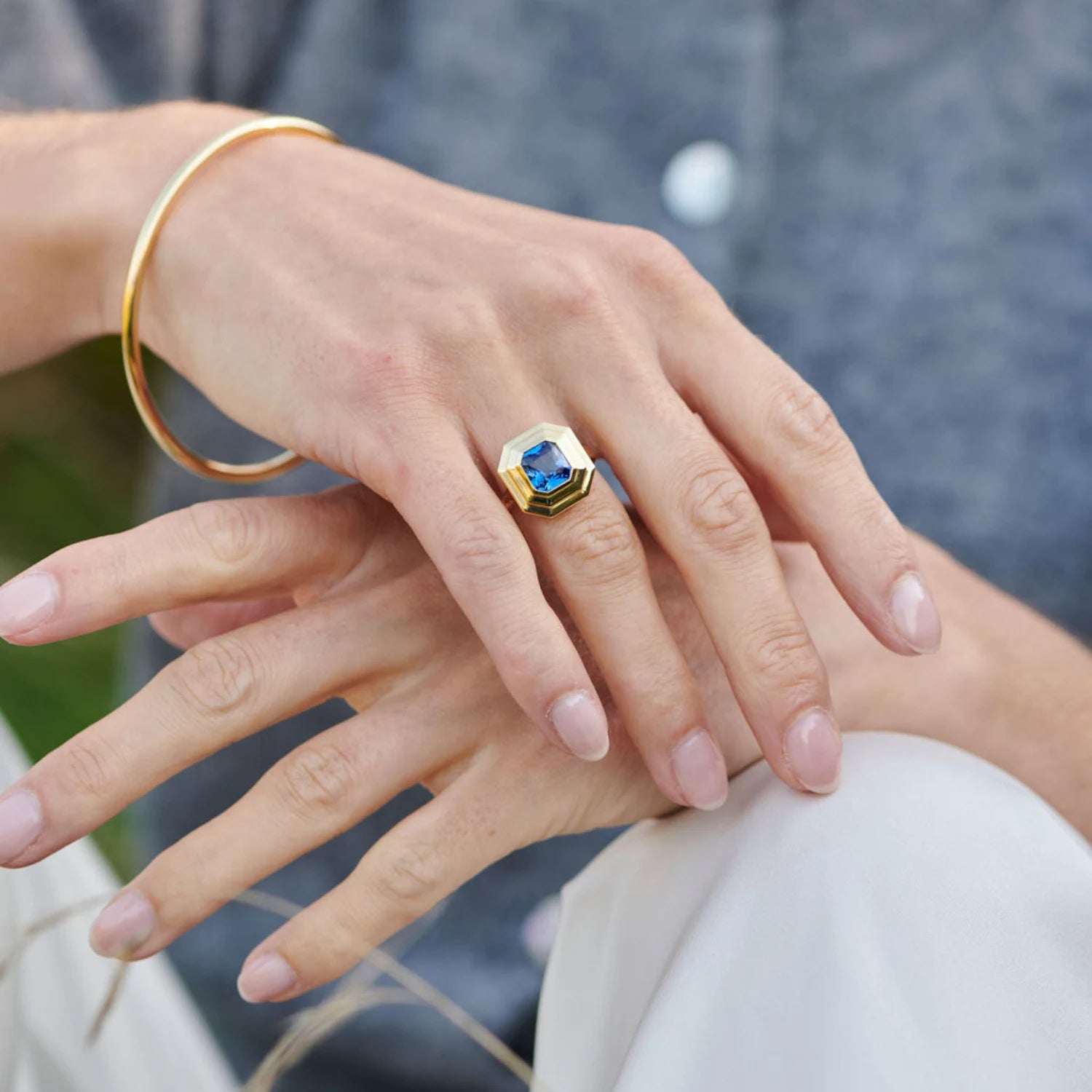 Hand model wearing Athena 3.02ct blue sapphire ring in 18k yellow gold with octagonal-cut gemstone and step detailing