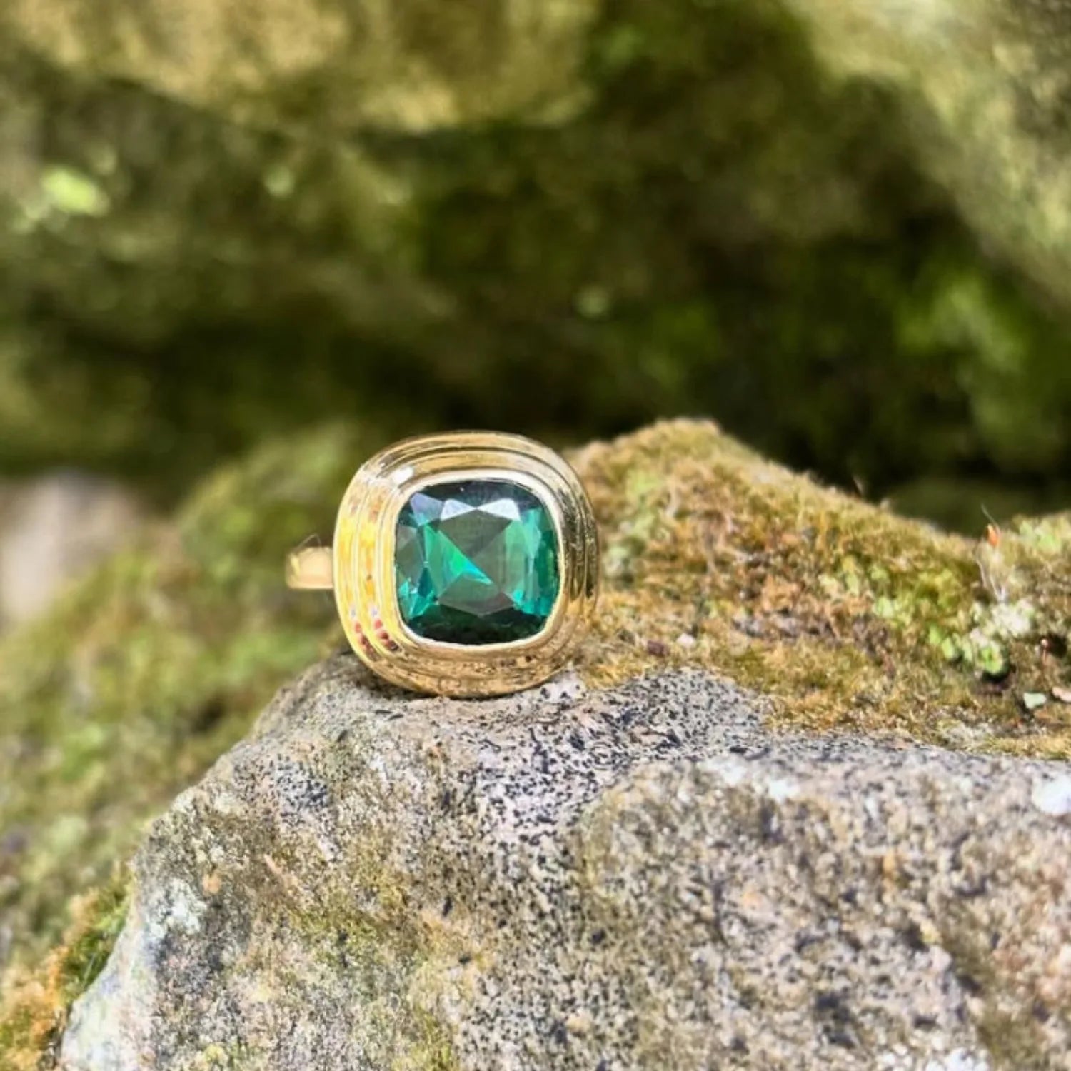 Close-up of Athena 4.56ct green tourmaline ring in 18k yellow gold with cushion-cut forest green tourmaline