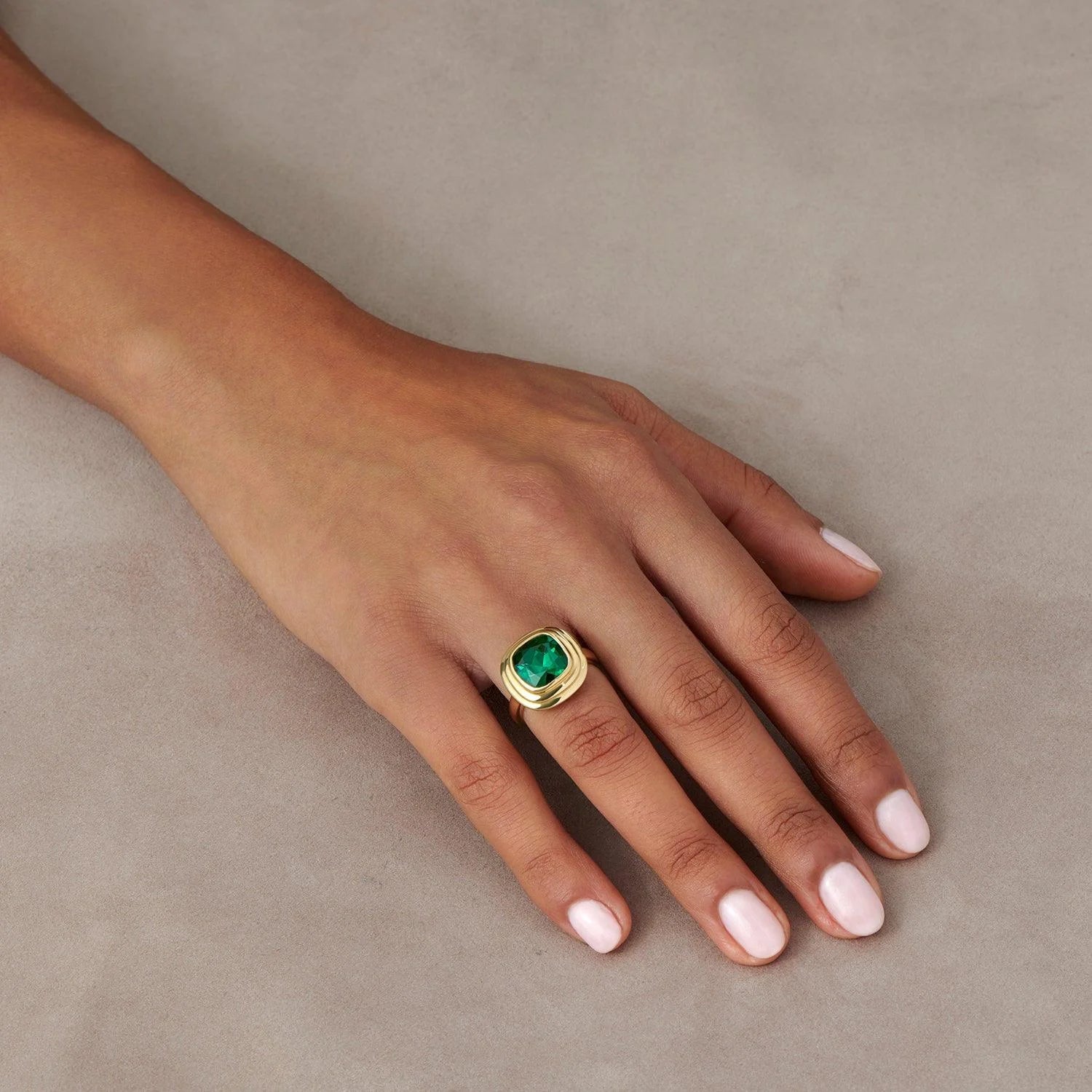 Hand model wearing Athena 4.56ct green tourmaline ring in 18k yellow gold with cushion-cut forest green tourmaline