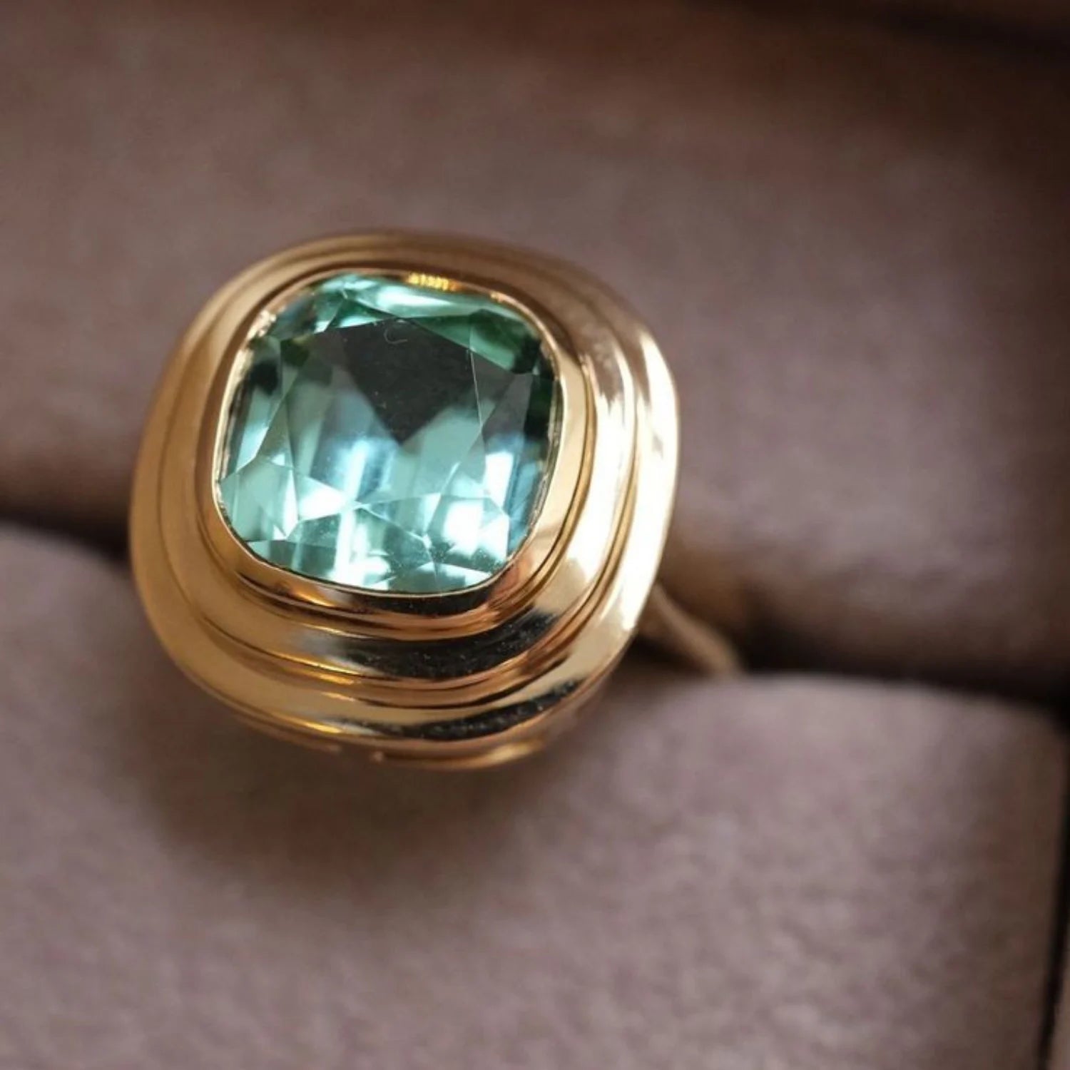 Close-up of 4.60ct pastel green tourmaline ring in 18k yellow gold with cushion-cut tourmaline showing soft green hue