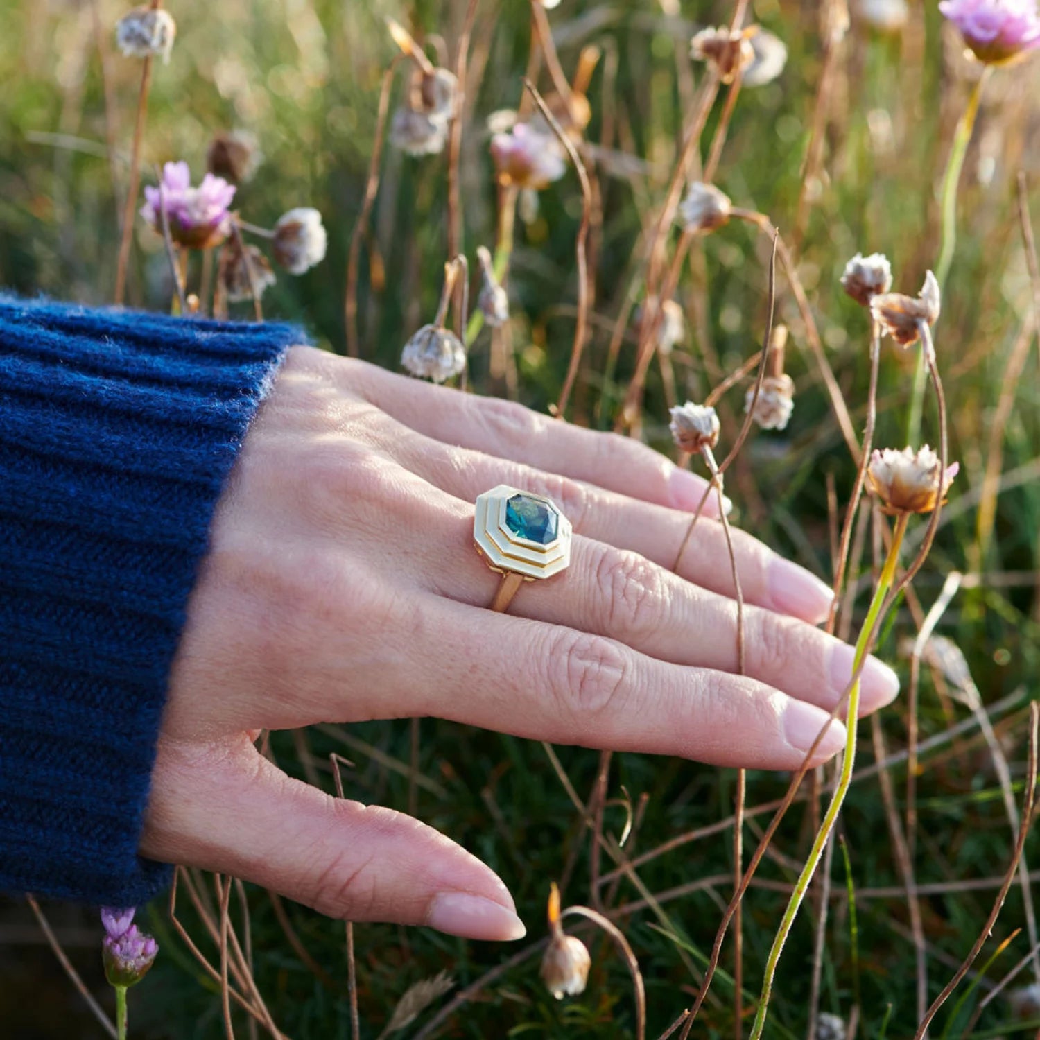 Hand model wearing Athena 4ct green tourmaline ring in 18k yellow gold with octagonal-cut gemstone and step detailing