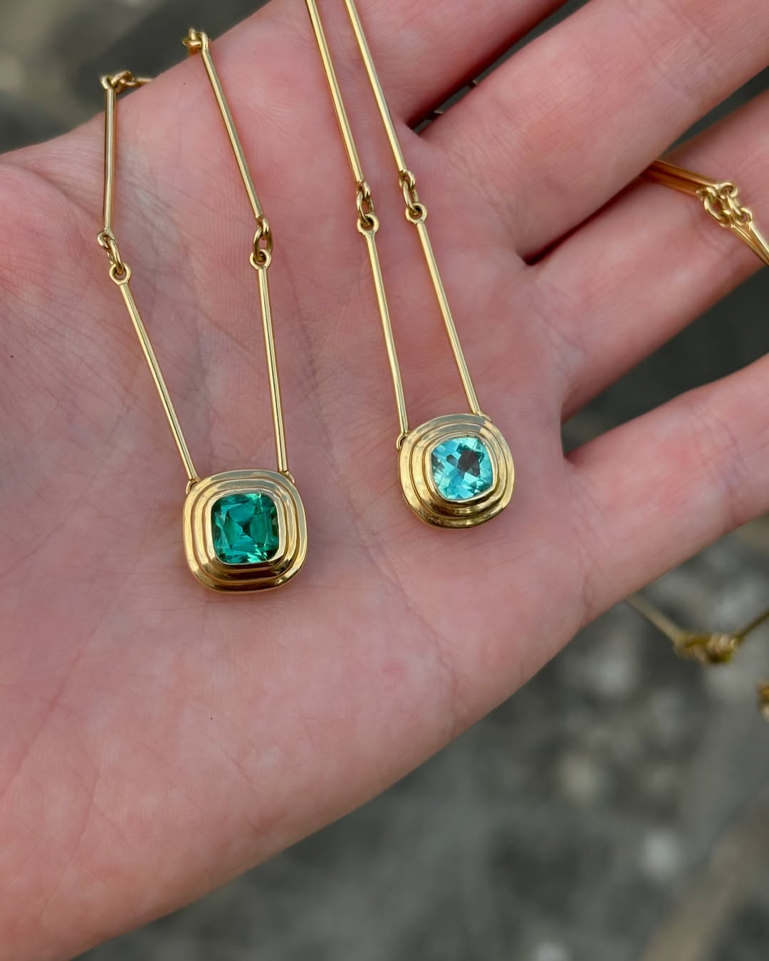 Athena 18k yellow gold necklace showing 1ct mint and vivid green tourmaline in gold step setting.