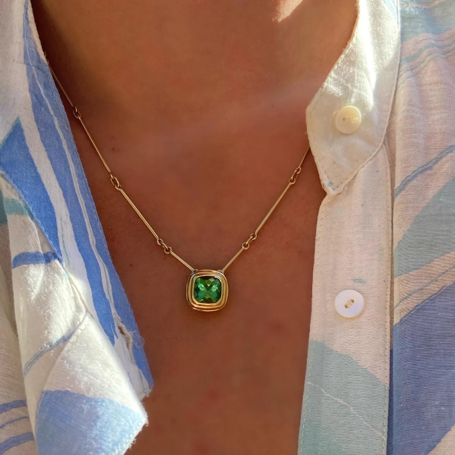 Model wearing Athena 3ct green tourmaline necklace in 18k yellow gold with cushion-cut green tourmaline