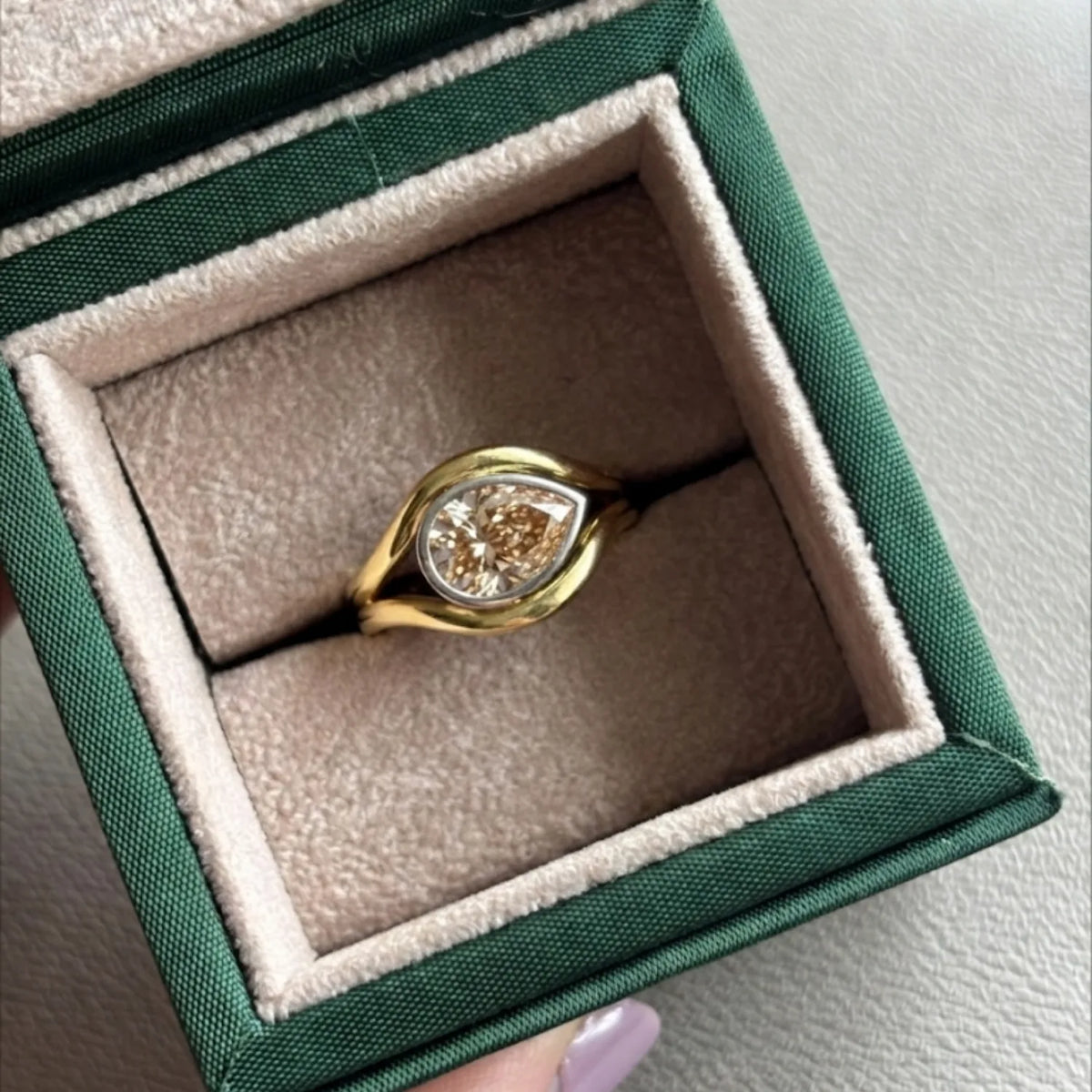 Close up of Brown Diamond Atlantis mermaid ring handcrafted in yellow and white gold with flowing curves