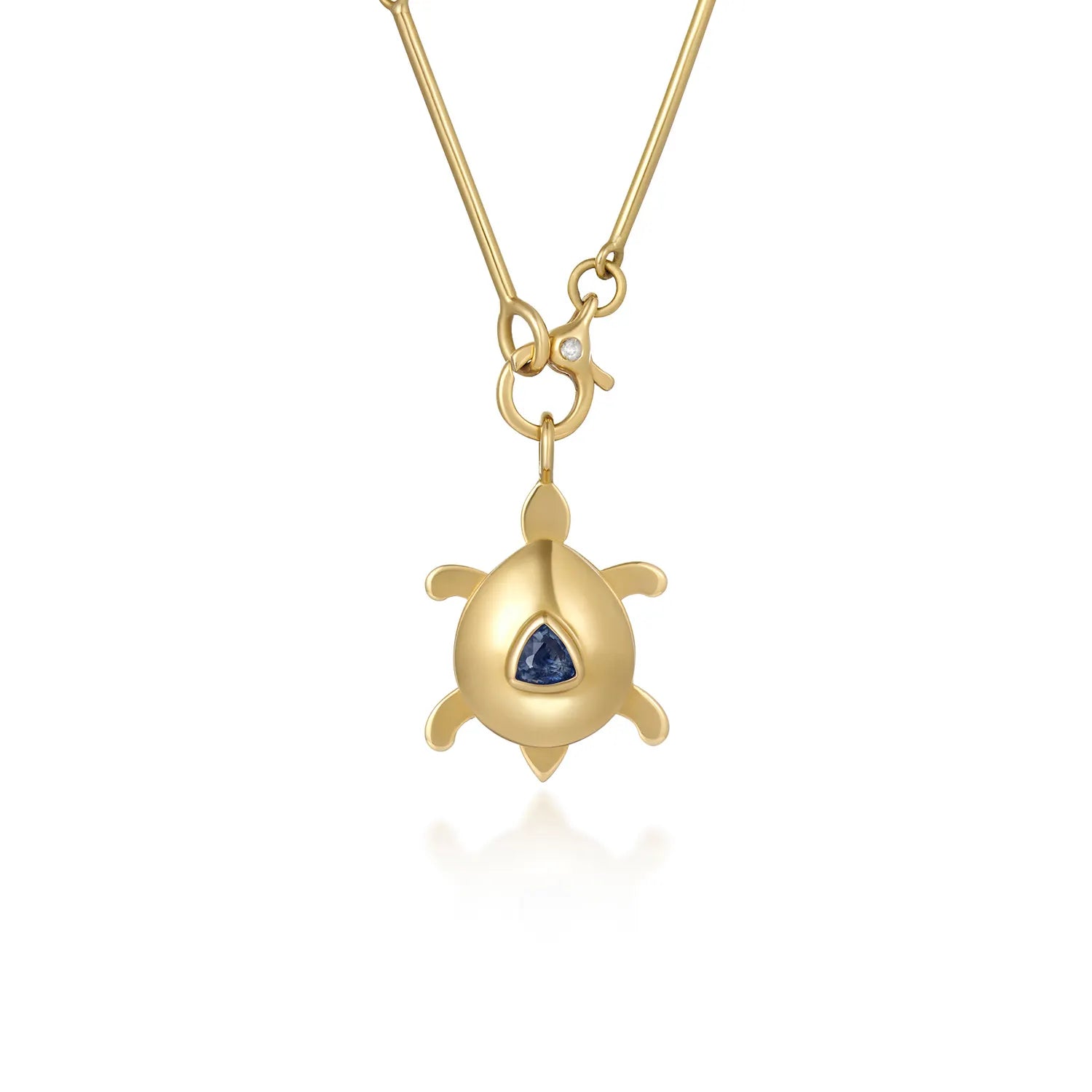 Atlantis dancing turtle sapphire charm in 18k yellow gold with trillion-cut sapphire worn on a cord or gold chain