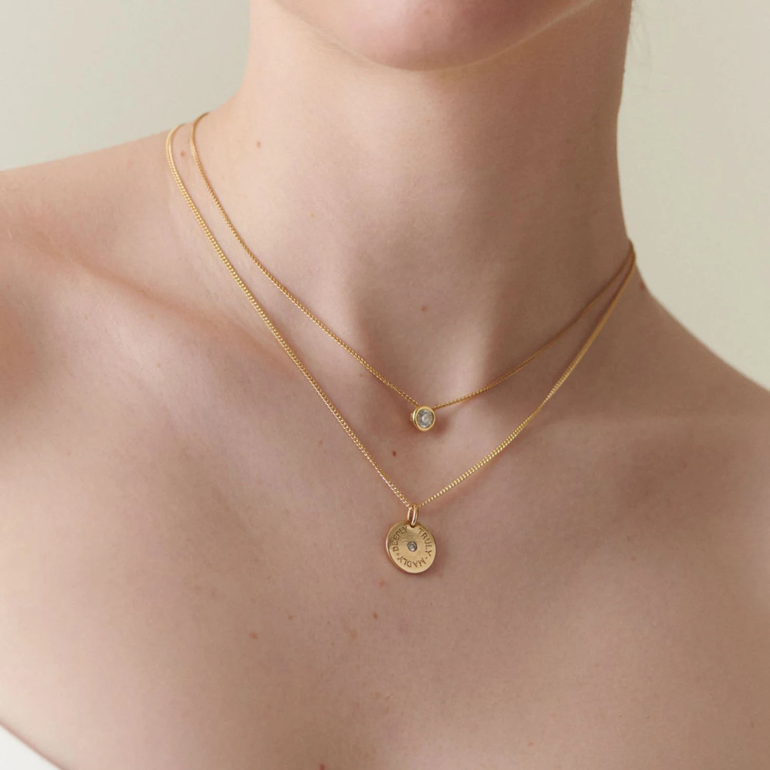Model wearing Atlantis Diamond Solitaire Necklace in 18k yellow gold with 0.50ct round brilliant-cut diamond