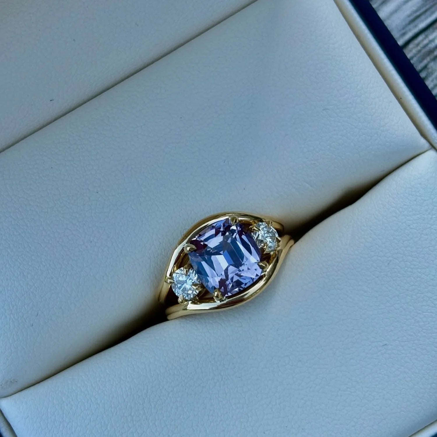 Close-up of Atlantis 3.62ct Lilac Spinel and Diamond Ring in solid 18k yellow gold with vivid lilac spinel and round white diamonds on mermaid-inspired band