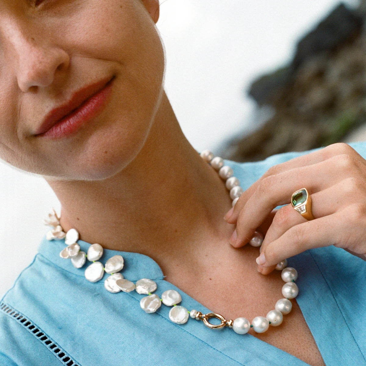 Model wearing Atlantis collection 18k yellow gold necklace featuring white Keshi pearls