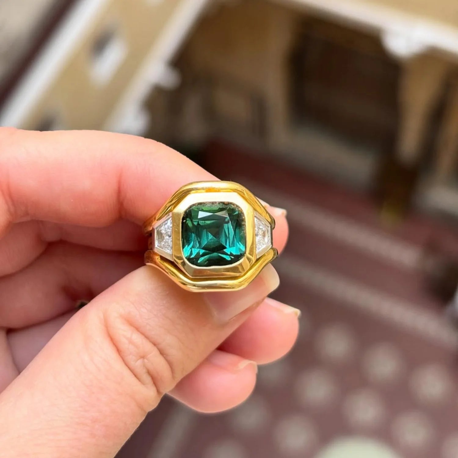 Close-up of Berlin Nights 5.96ct green tourmaline ring in 18k yellow gold and platinum with geometrically cut gemstone and diamond accents