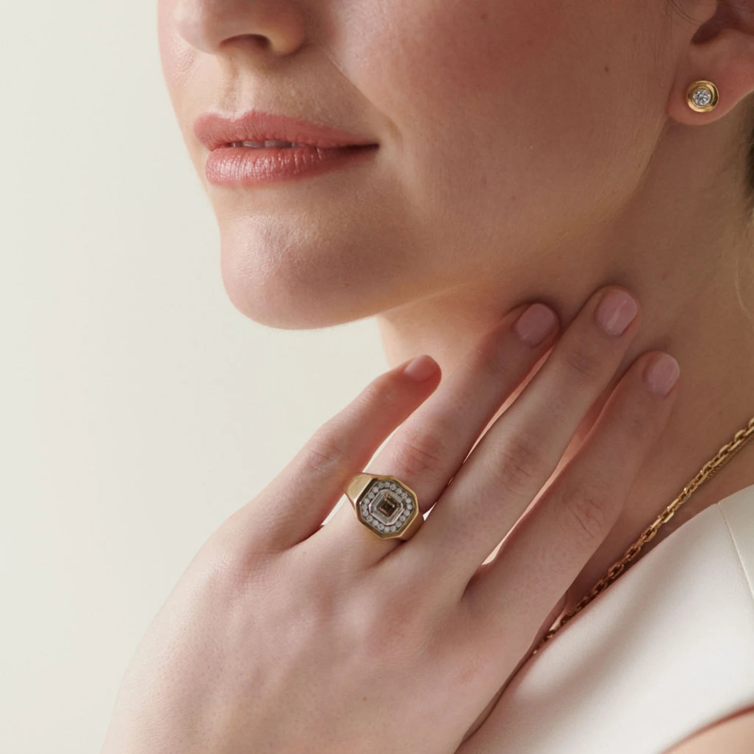 Close-up of Berlin Nights Cognac Brown Diamond Ring in 18k yellow gold featuring 1.24ct octagonal-cut cognac brown diamond with 0.54ct halo styled with diamond stud earrings
