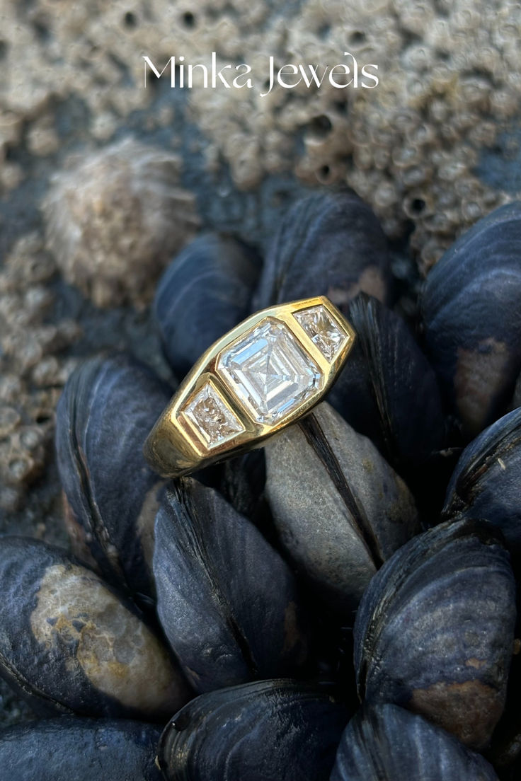 Side view of 18k yellow gold engagement ring with 2ct octagon (Asscher) diamond and 0.50ct trapezoid diamonds, showcasing protective chunky band