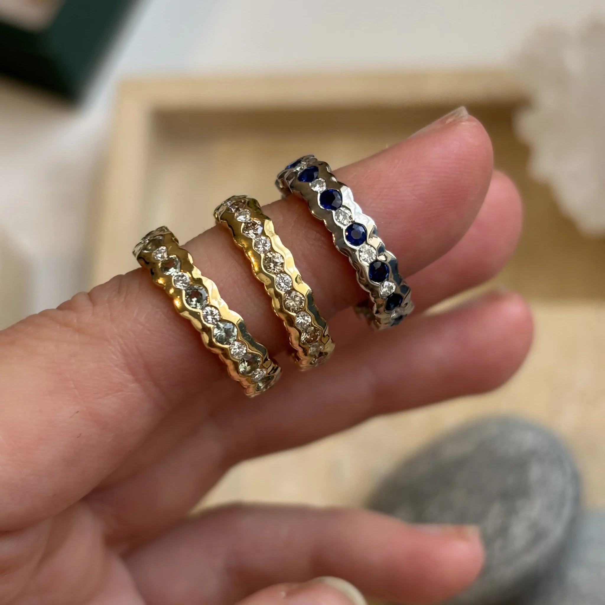 Eternity Collection rings in 18k yellow gold and silver featuring sapphires and white and brown diamonds