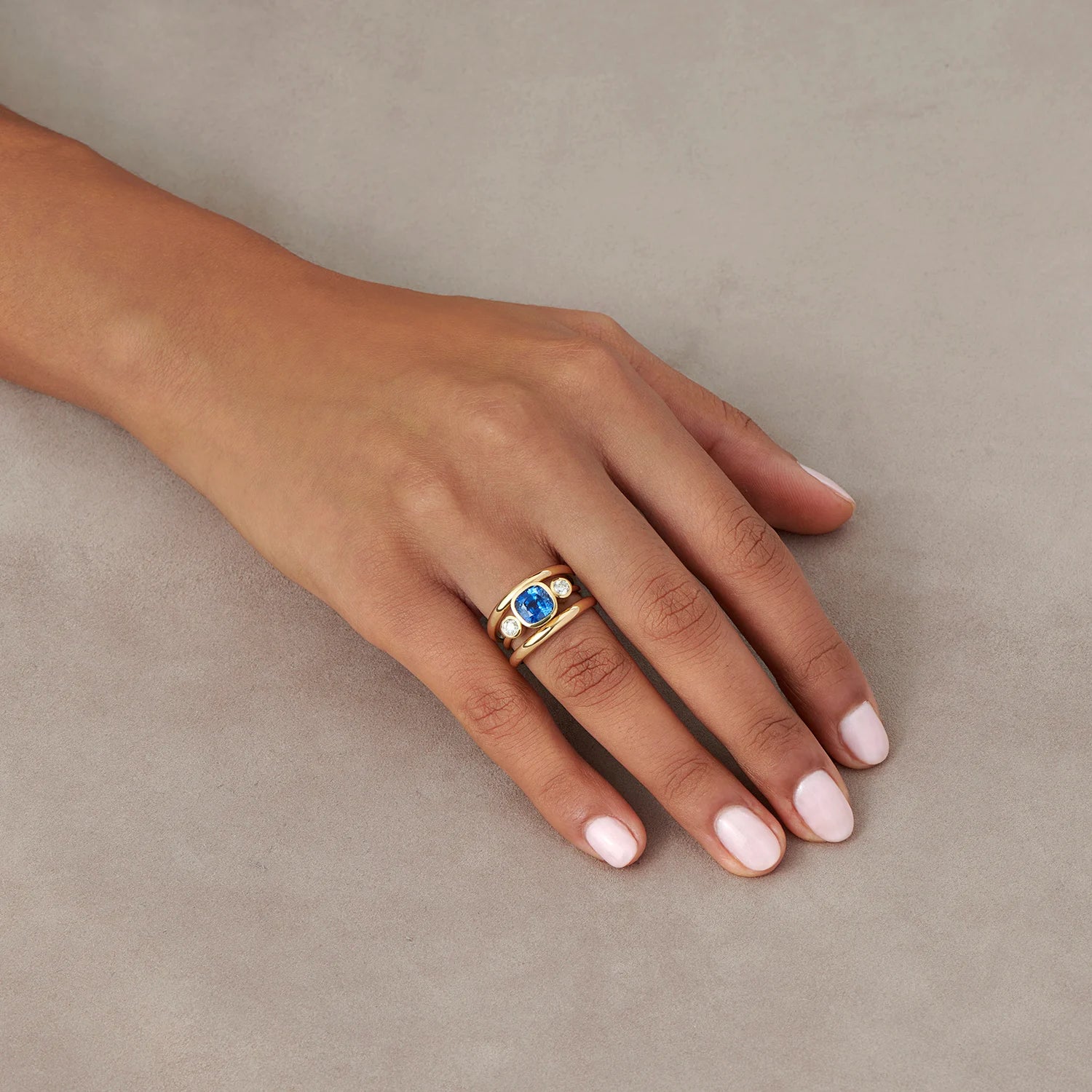 Hand model wearing Les Trois Vallées sapphire and diamond ring in 18k yellow gold with 2.35ct Royal Blue Sri Lankan sapphire and 0.50ct round diamonds