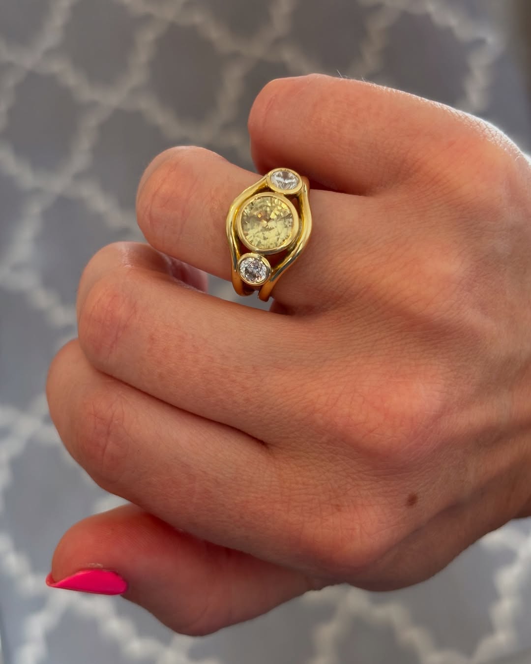 Hand model wearing 18k yellow gold ring with 3.08ct no-heat Sri Lankan yellow sapphire and white diamonds