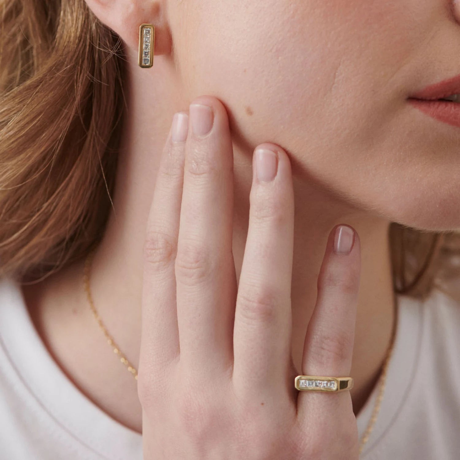 Model wearing Ley Lines Diamond pinky ring in 18k yellow gold with five carré-cut diamonds totaling 0.50ct