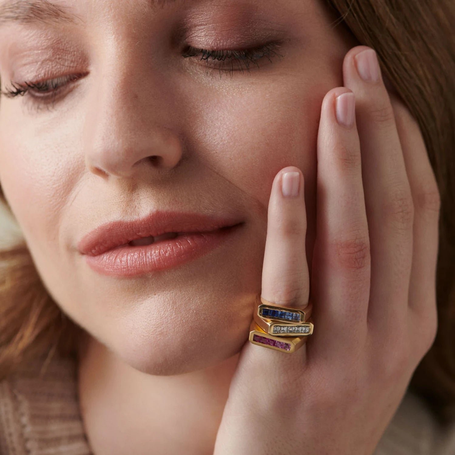 Model wearing Ley Lines Pinky Rings collection, 18k gold with five square-cut in ombre tones stacked together