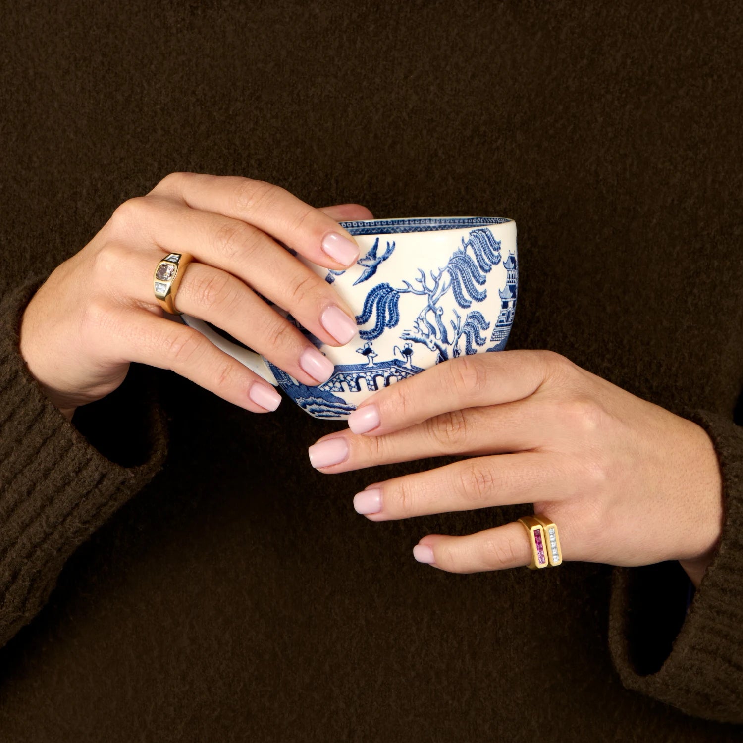 Hand model wearing Ley Lines Pink Ombre Sapphire Pinky Ring, 18k gold with five square-cut pink sapphires in ombre tones stacked with Ley Lines Diamond Pinky Ring