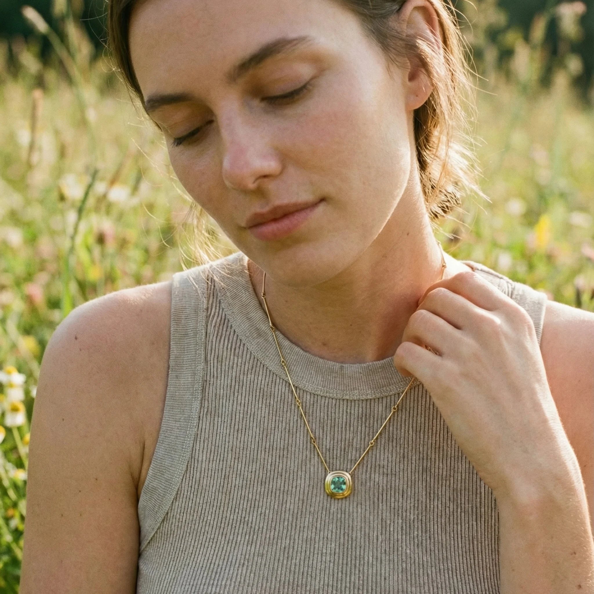 Model wearing Athena Collection 1ct mint green tourmaline necklace in 18k yellow gold with cushion-cut mint green tourmaline pendant