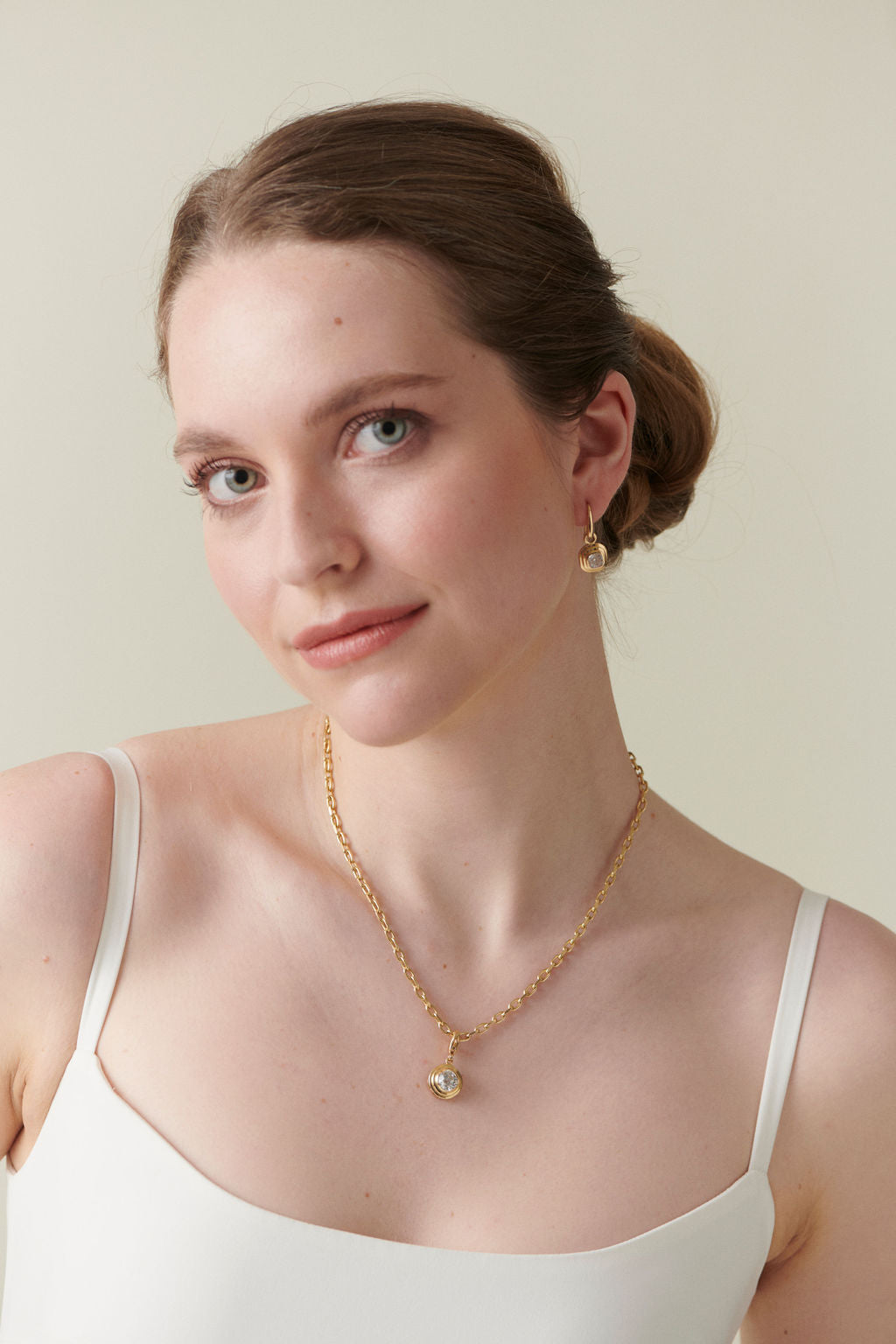 Model wearing Athena collection 2ct Old Cut Cushion Diamond necklace in 18k yellow gold with chunky chain, styled with matching Diamond drop earrings