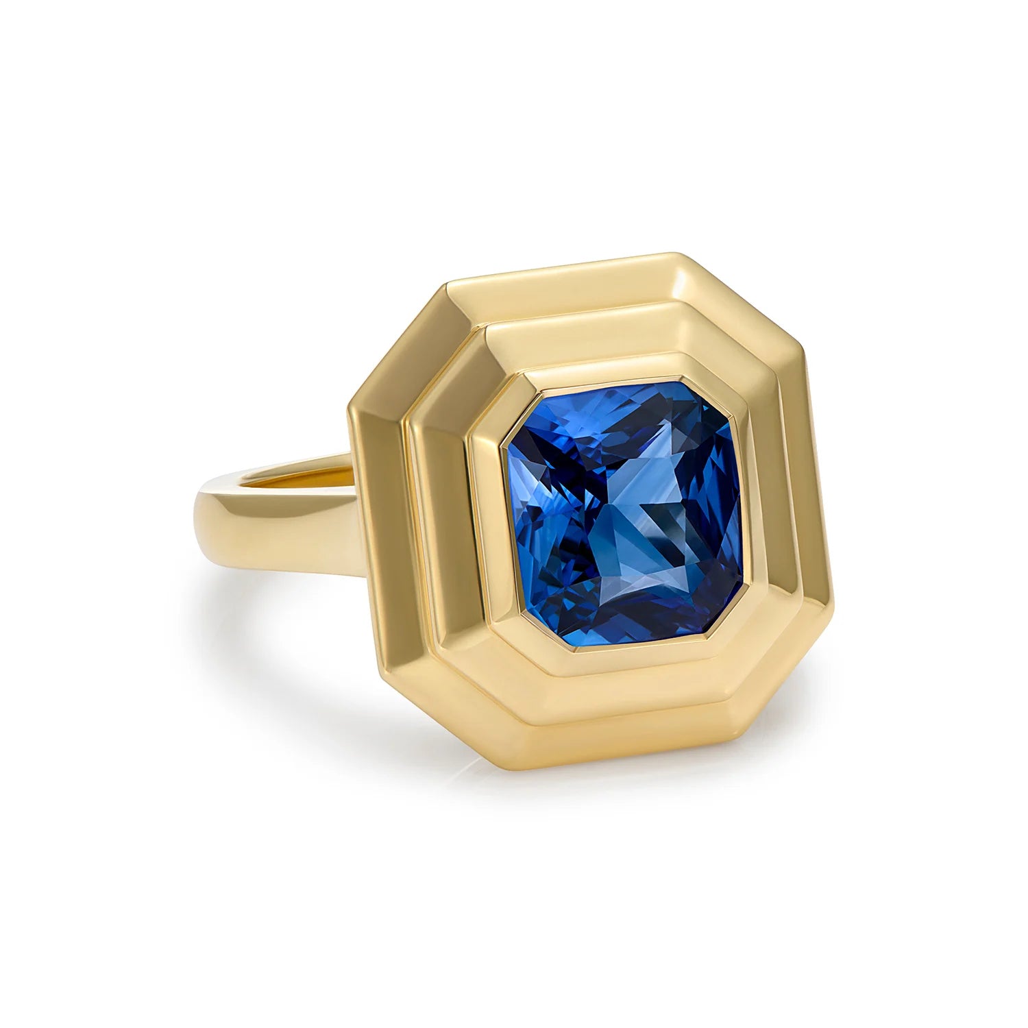Side view of Athena 3.02ct blue sapphire ring in 18k yellow gold showing sculptural step detailing and octagonal gemstone setting