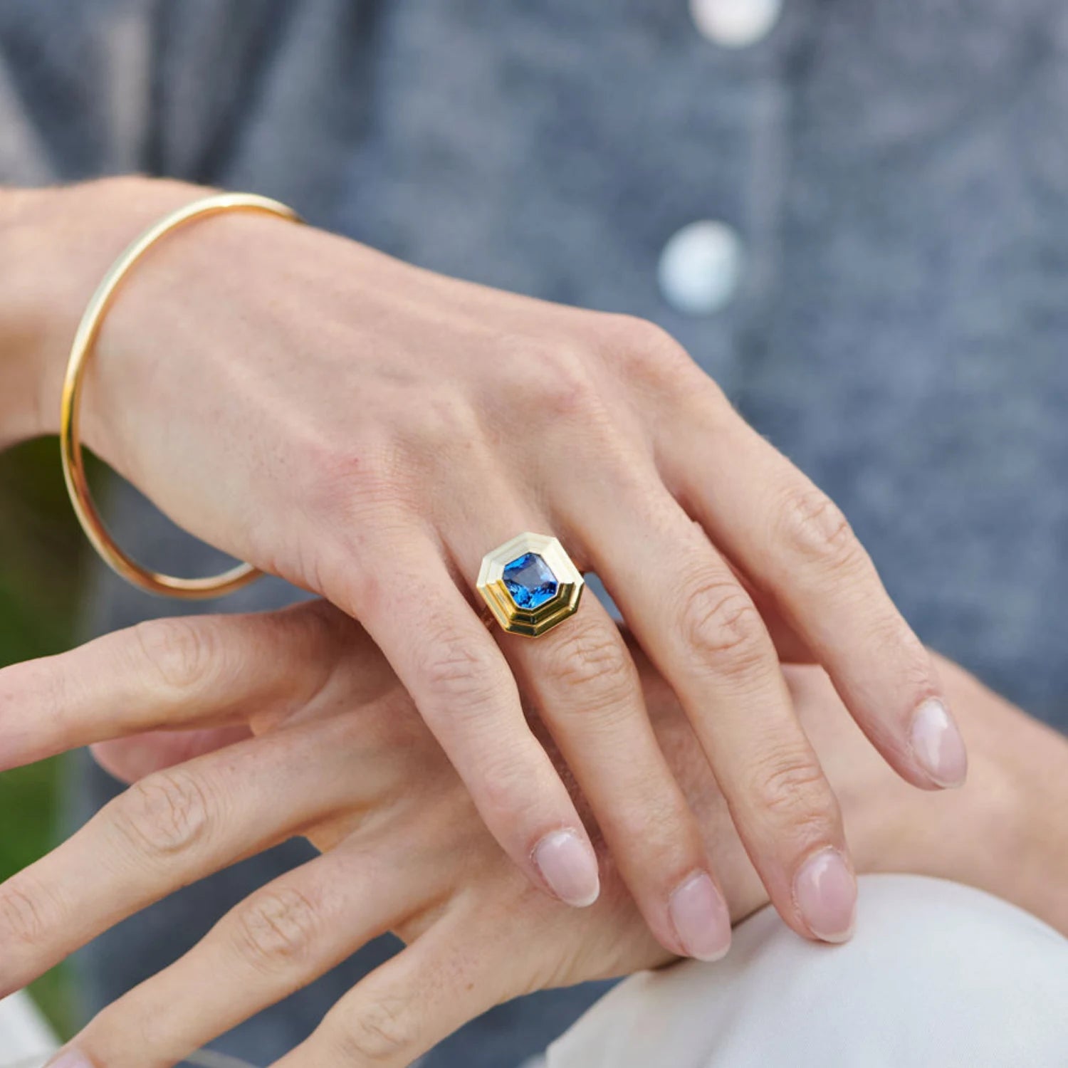 Hand model wearing Athena 3.02ct blue sapphire ring in 18k yellow gold with octagonal-cut gemstone and step detailing