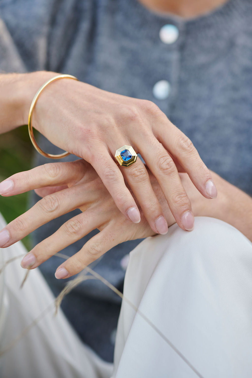 18k yellow gold Athena blue sapphire ring worn on hand by Minka Jewels model