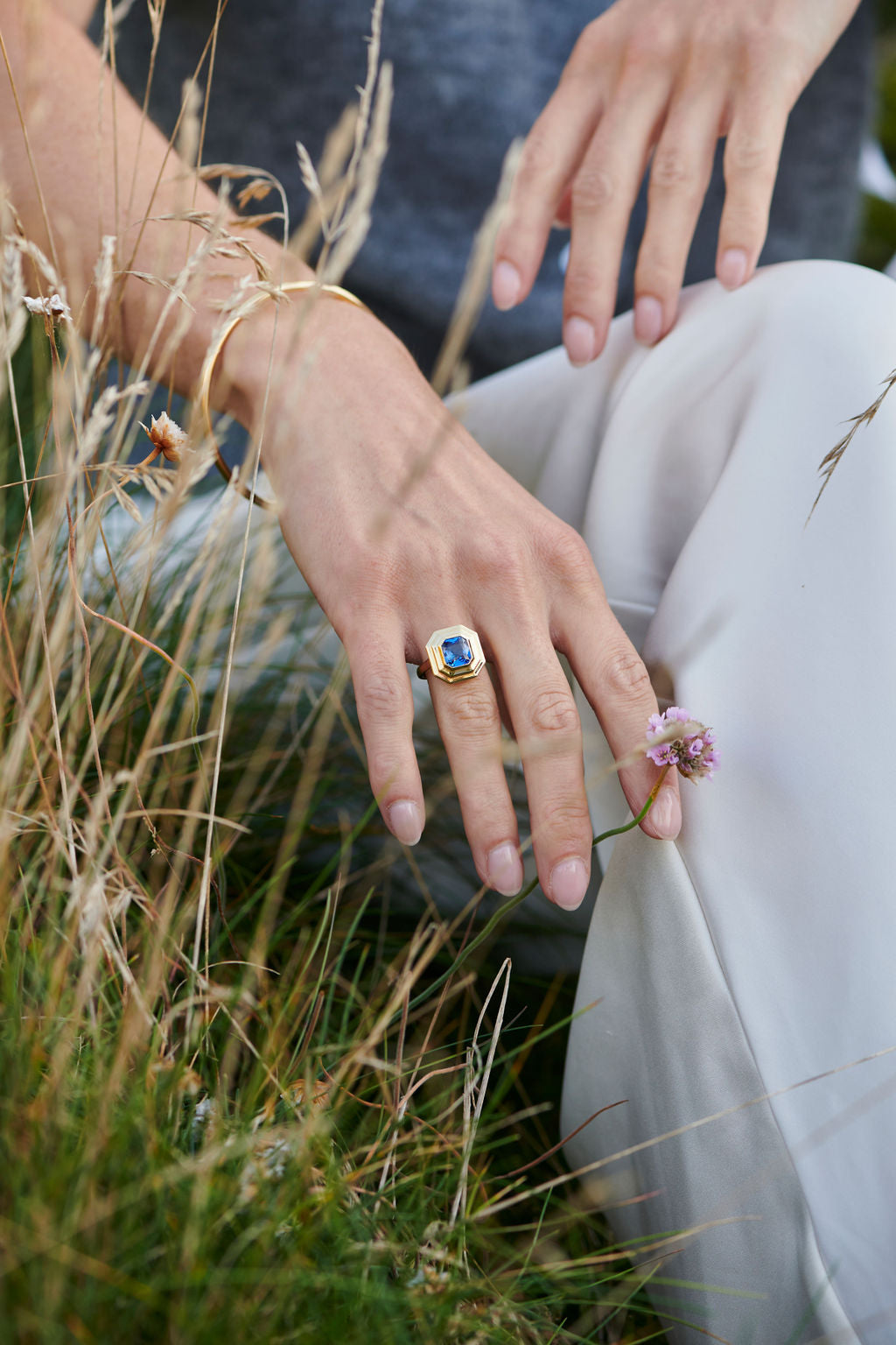 18k yellow gold Athena blue sapphire ring worn on hand by Minka Jewels model