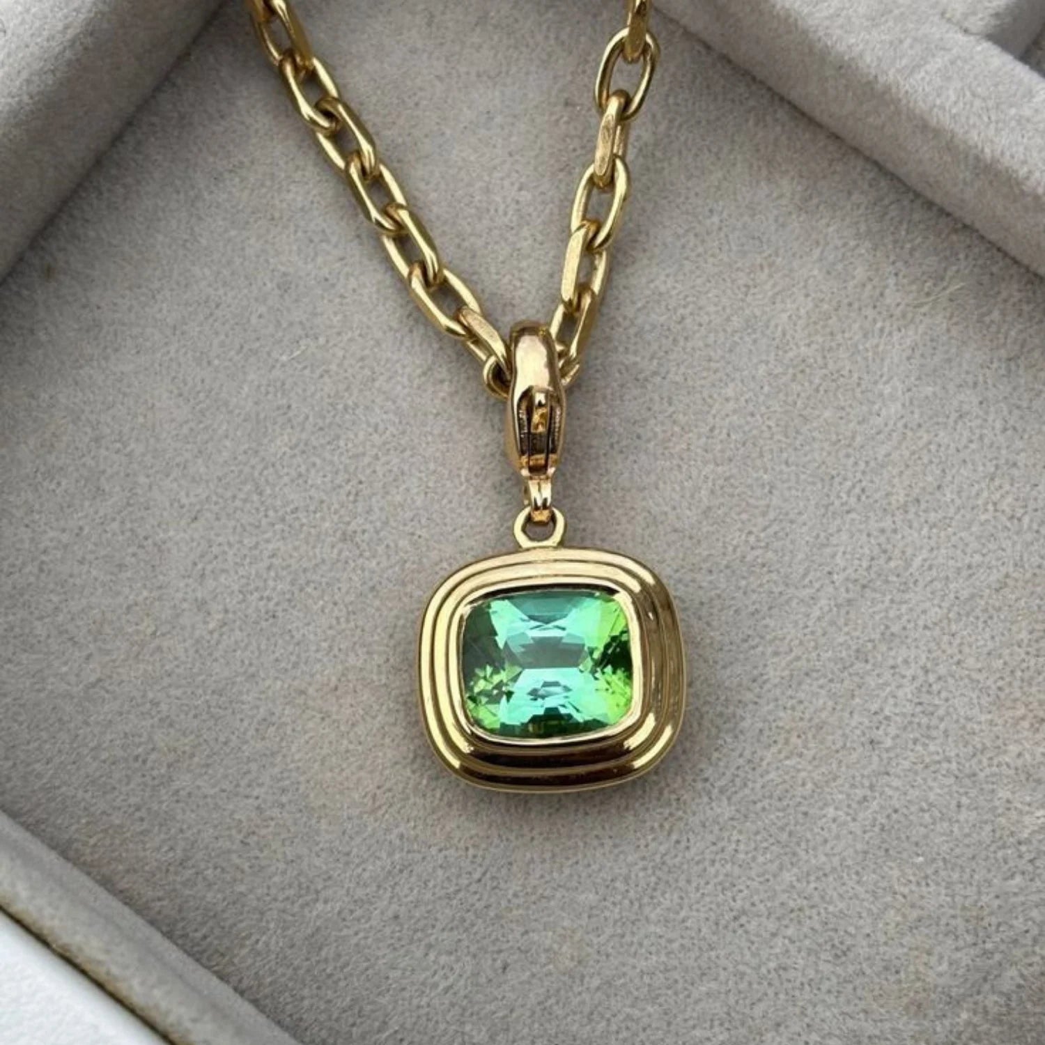 Close-up of Athena 5.35ct vivid green tourmaline necklace in 18k yellow gold with antique cushion-cut gemstone