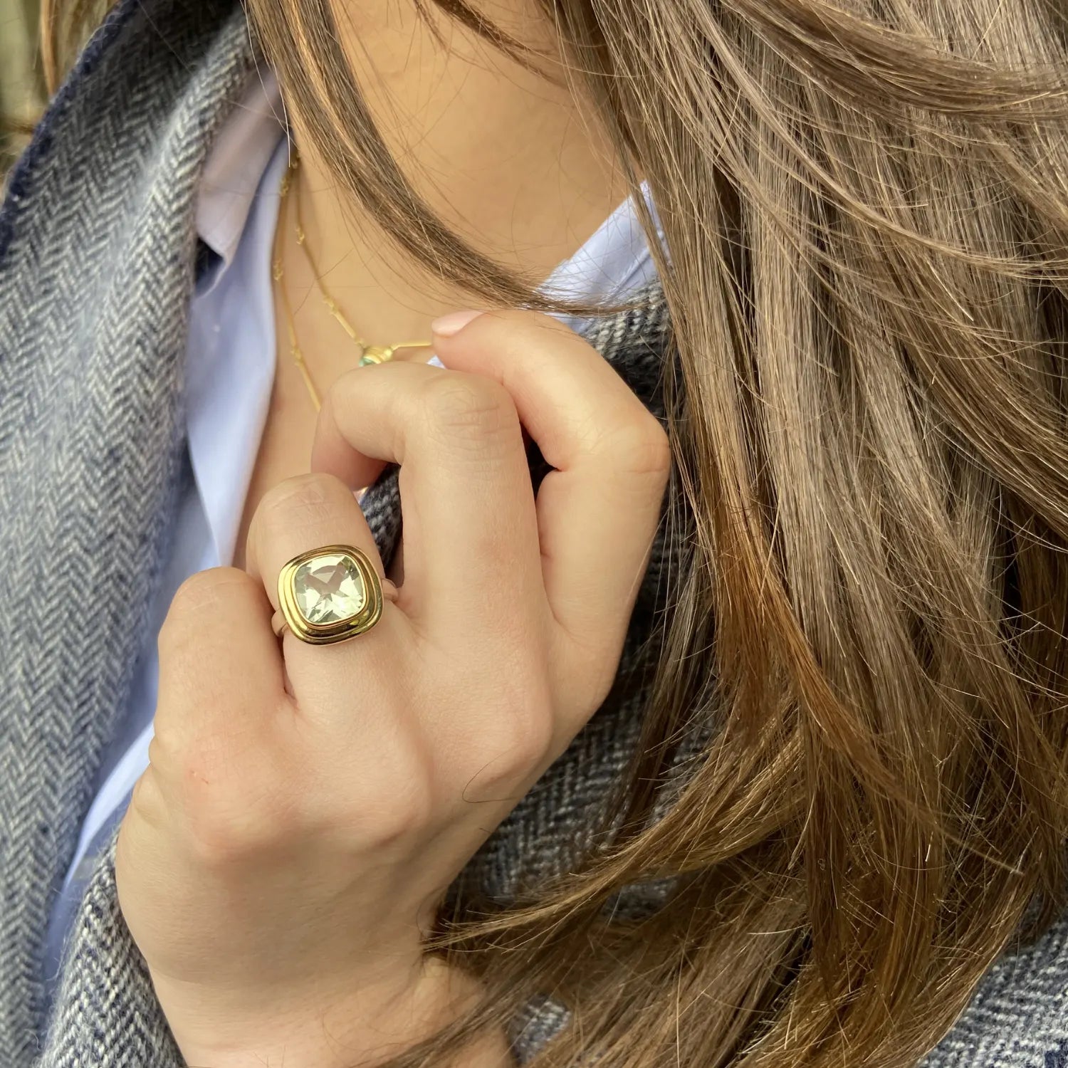 Model wearing Athena 4ct green amethyst ring in 14k yellow gold and sterling silver with cushion-cut gemstone