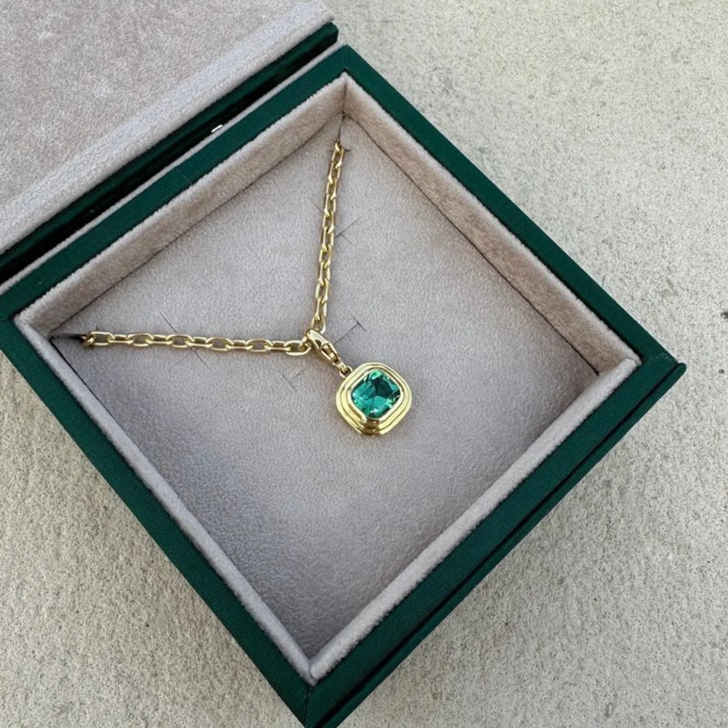 Athena green tourmaline pendant necklace in 18k yellow gold featuring cushion-cut green tourmaline and clip clasp in minkajewels jewellery box