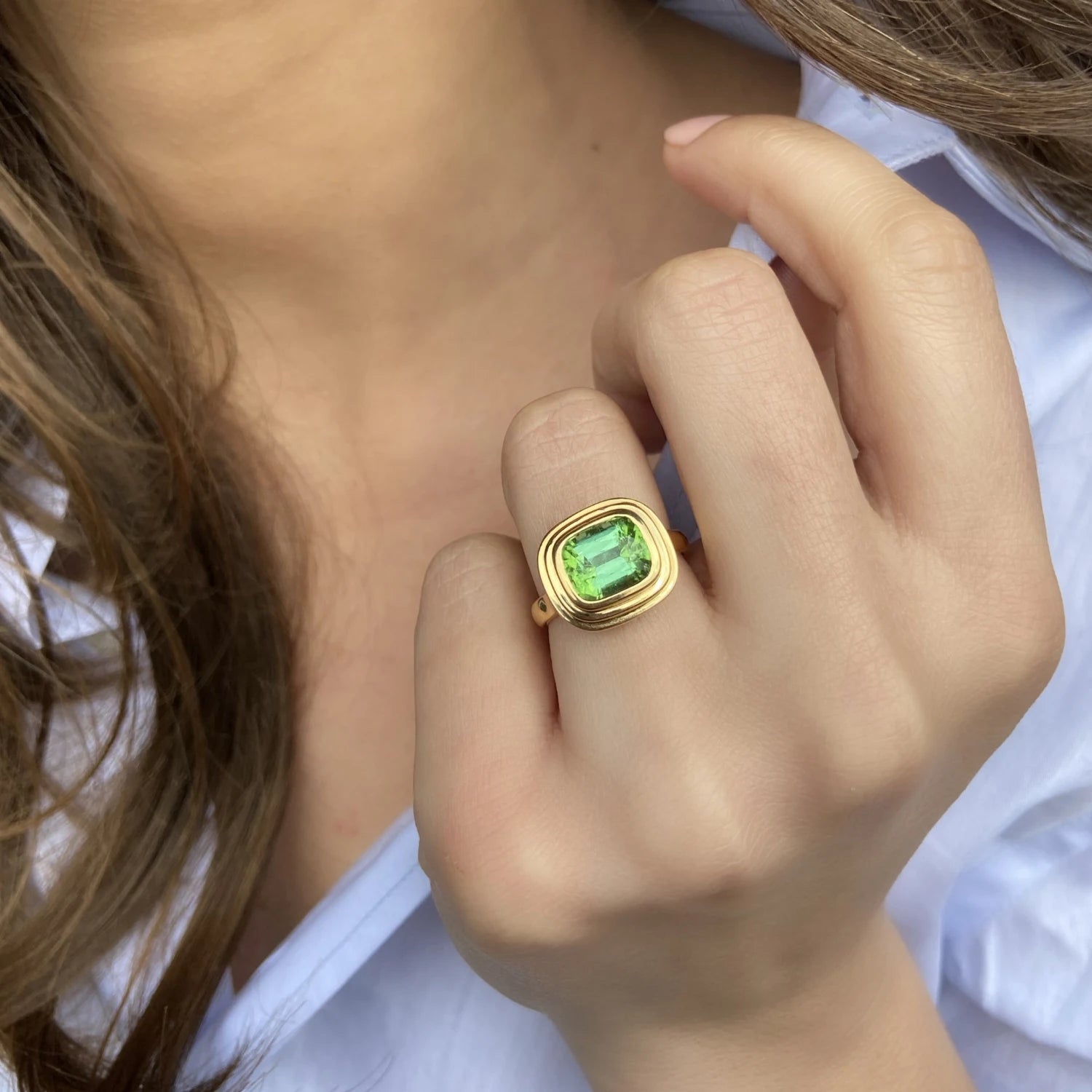 Model wearing Athena Medium 3.68ct green tourmaline ring in 18k yellow gold as a statement piece