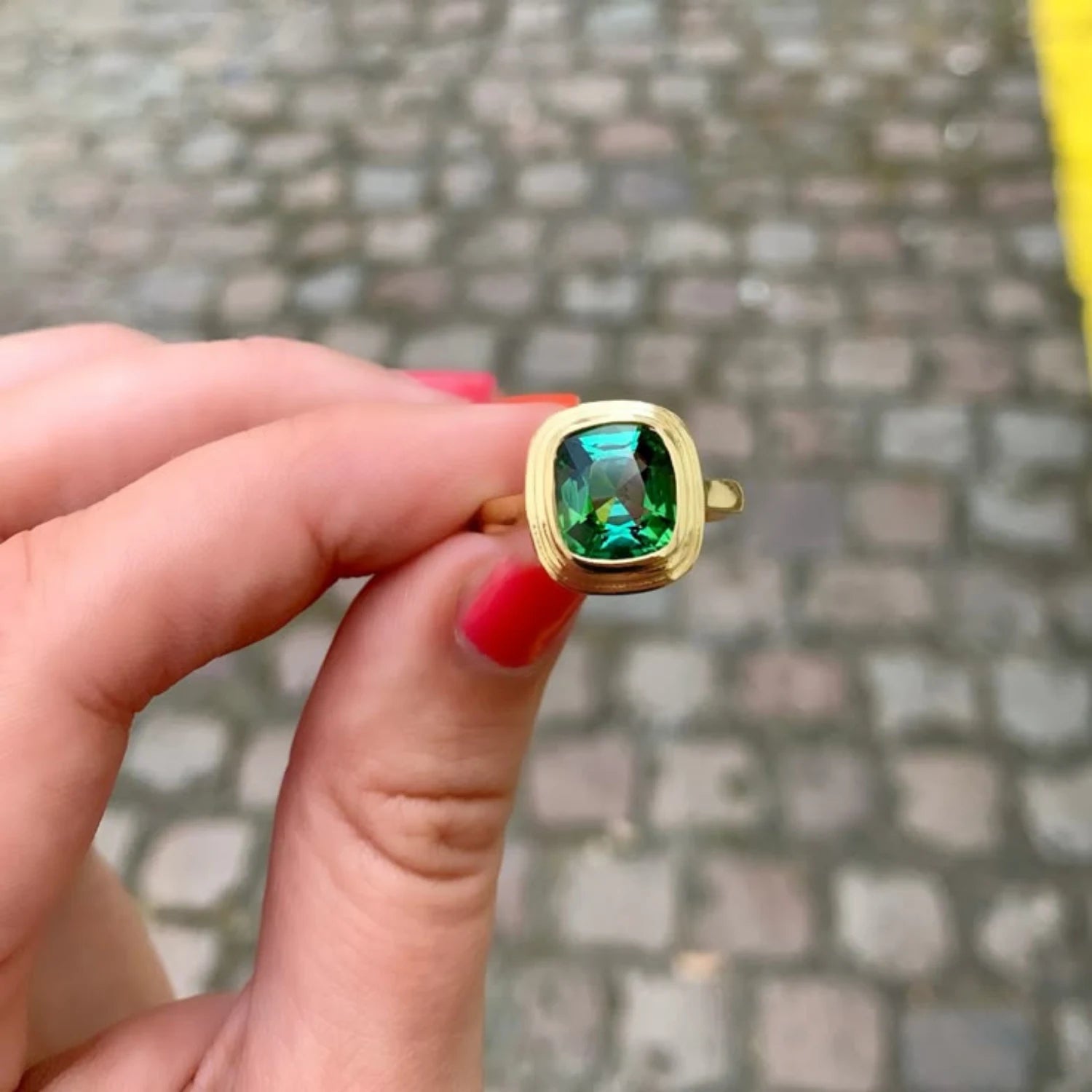 Close-up of Athena 2.25ct green tourmaline ring in 18k yellow gold with cushion-cut vivid green tourmaline