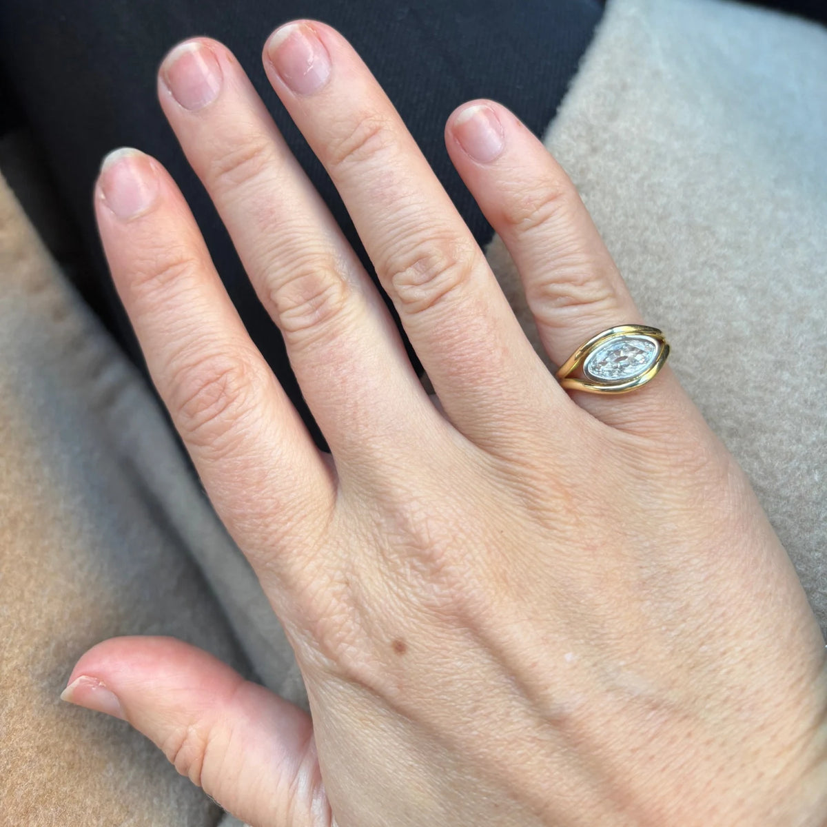 Close-up of Atlantis 2ct Diamond Mermaid Ring in yellow and white gold with 2ct oval-shaped white diamond on mermaid tail-inspired band