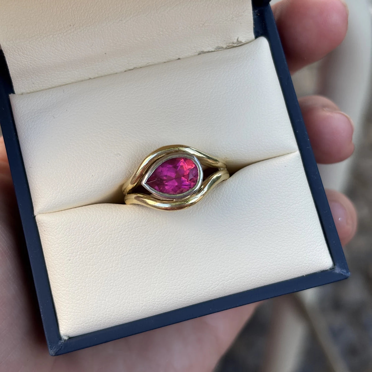 Close up of Pink tourmaline Atlantis mermaid ring handcrafted in yellow and white gold with flowing curves