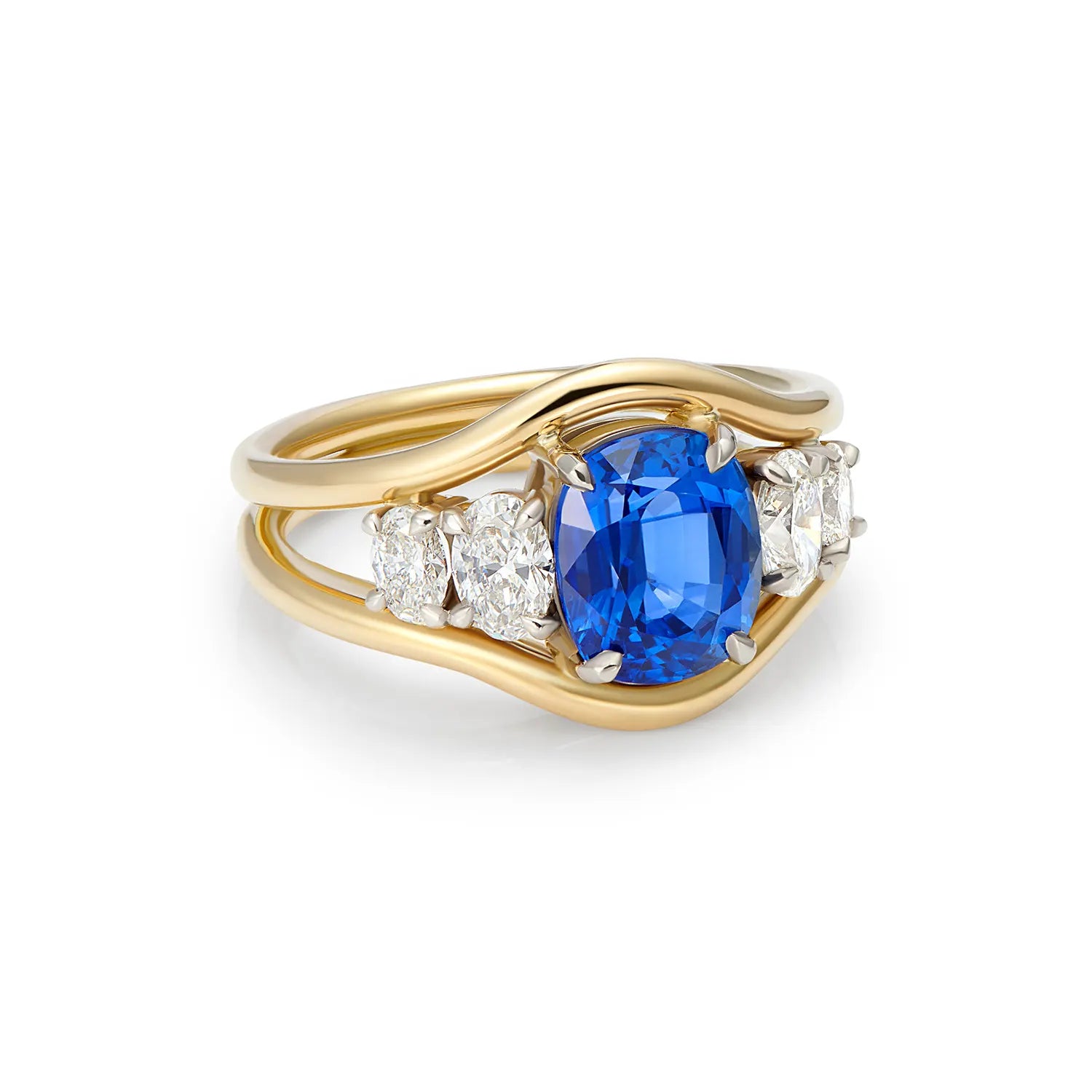 Side view of Atlantis sapphire and diamond mermaid ring highlighting 3.04ct royal blue sapphire and flowing 18k yellow gold design with oval diamonds