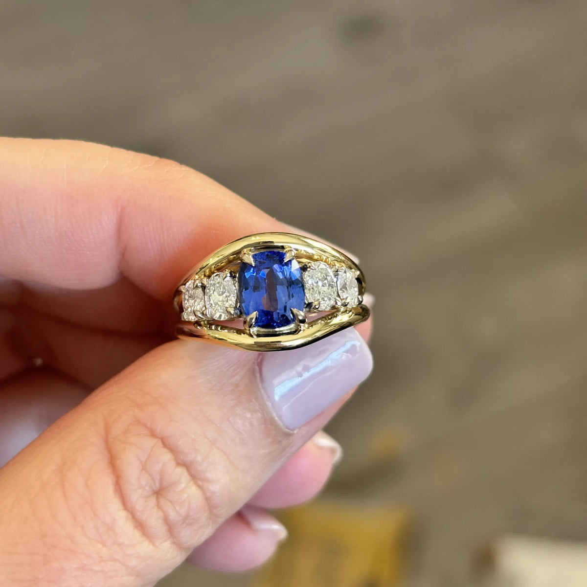 Close-up of Atlantis 3.04ct blue sapphire mermaid ring in 18k yellow gold with square cushion-cut blue sapphire and 4 oval white diamonds