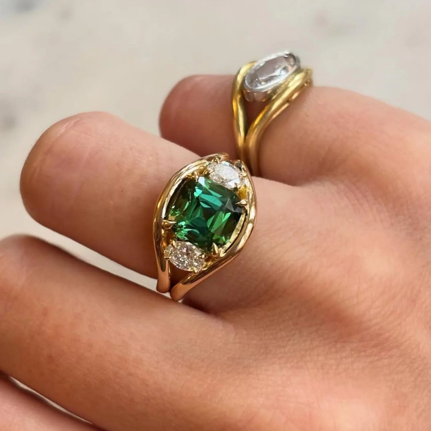Hand wearing Atlantis green tourmaline mermaid ring in 18k yellow gold with 4.70ct center stone and diamond accents