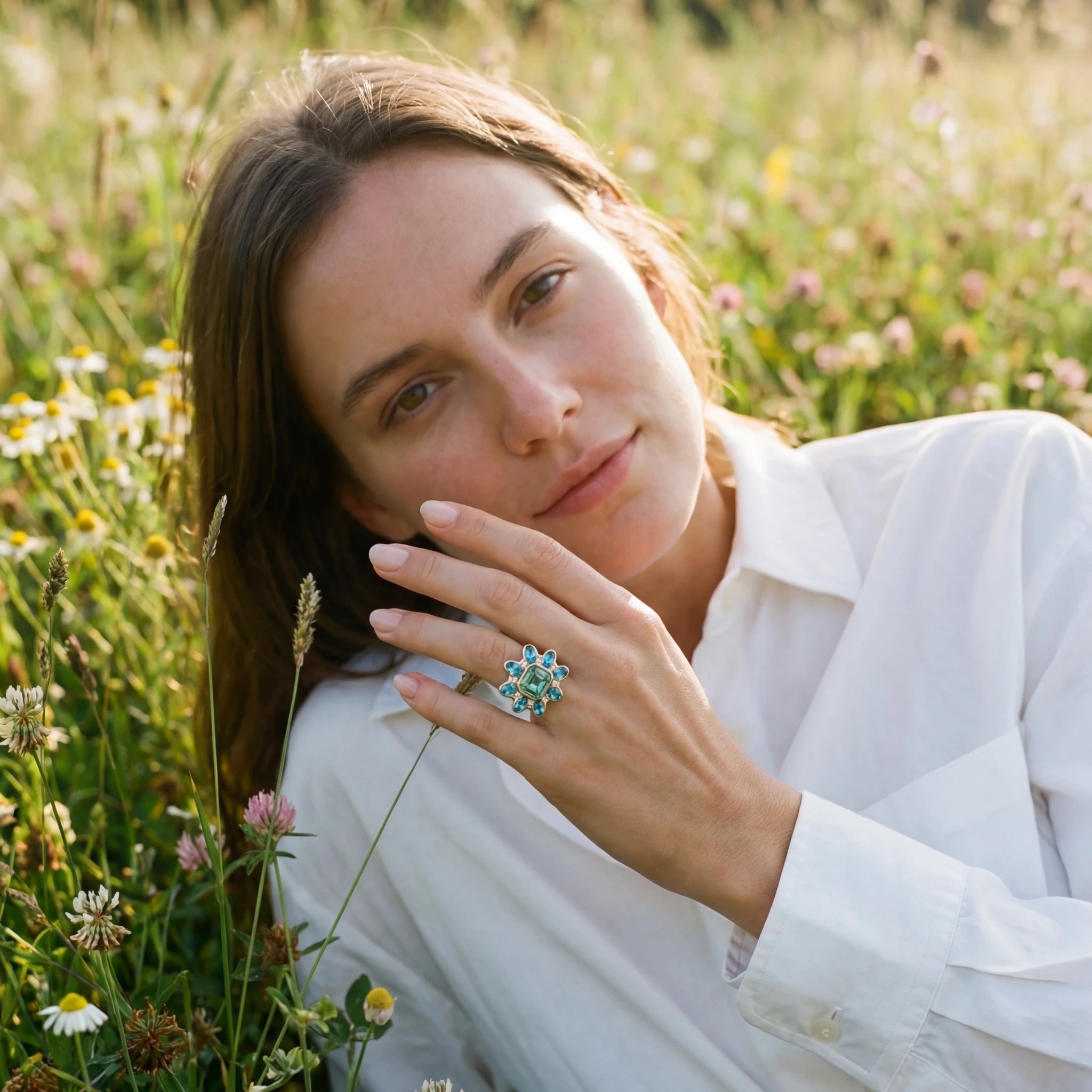 Model wearing Atlantis collection 18k yellow gold ring featuring 5.30ct green Tourmaline, 3.39ct Aquamarine, and diamonds
