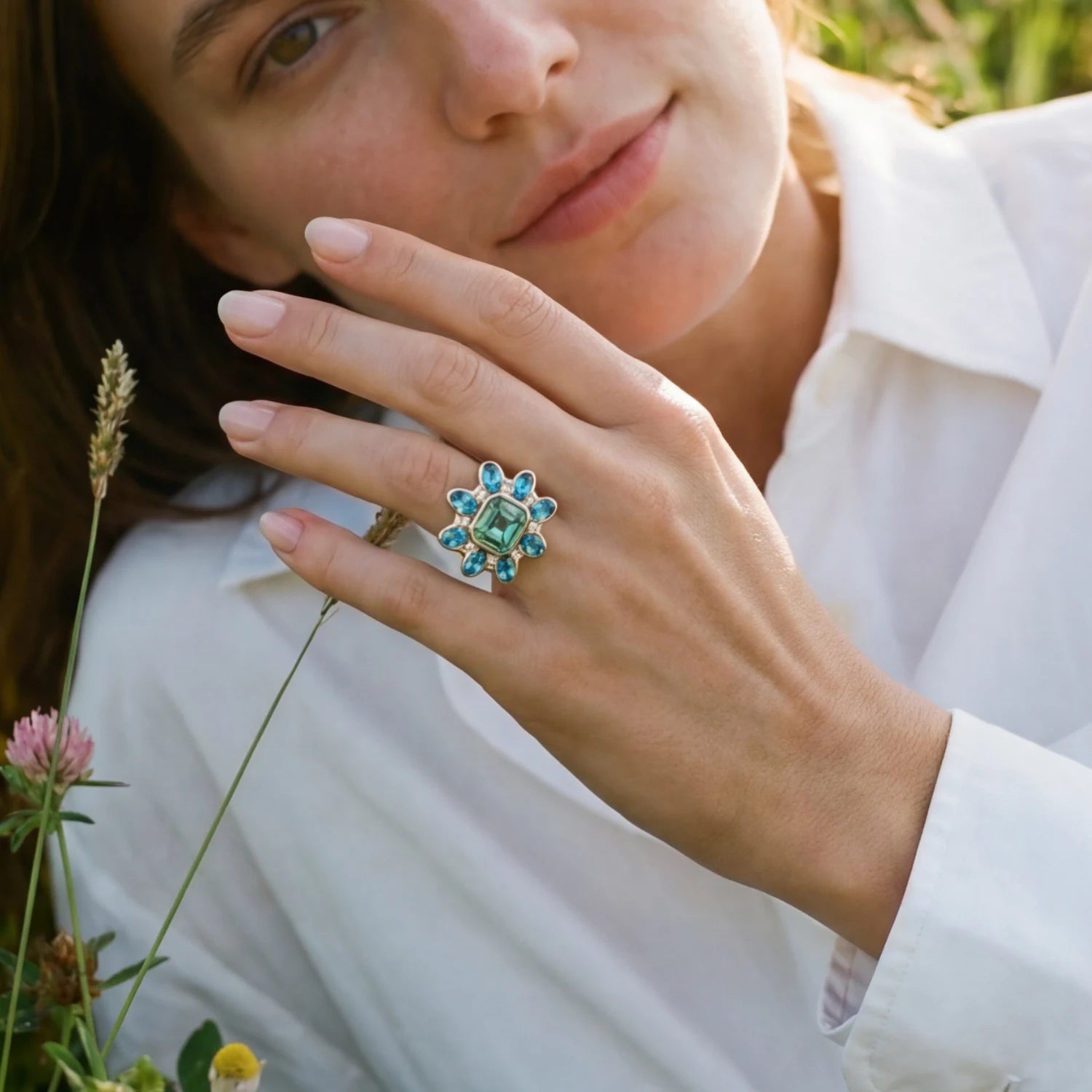 Atlantis Tourmaline, Aquamarine, and Diamond ring on model’s hand, handcrafted in 18k yellow gold, featuring 5.30ct ocean green tourmaline, 3.39ct Santa Maria aquamarines, and 0.32ct diamonds, ocean-inspired design