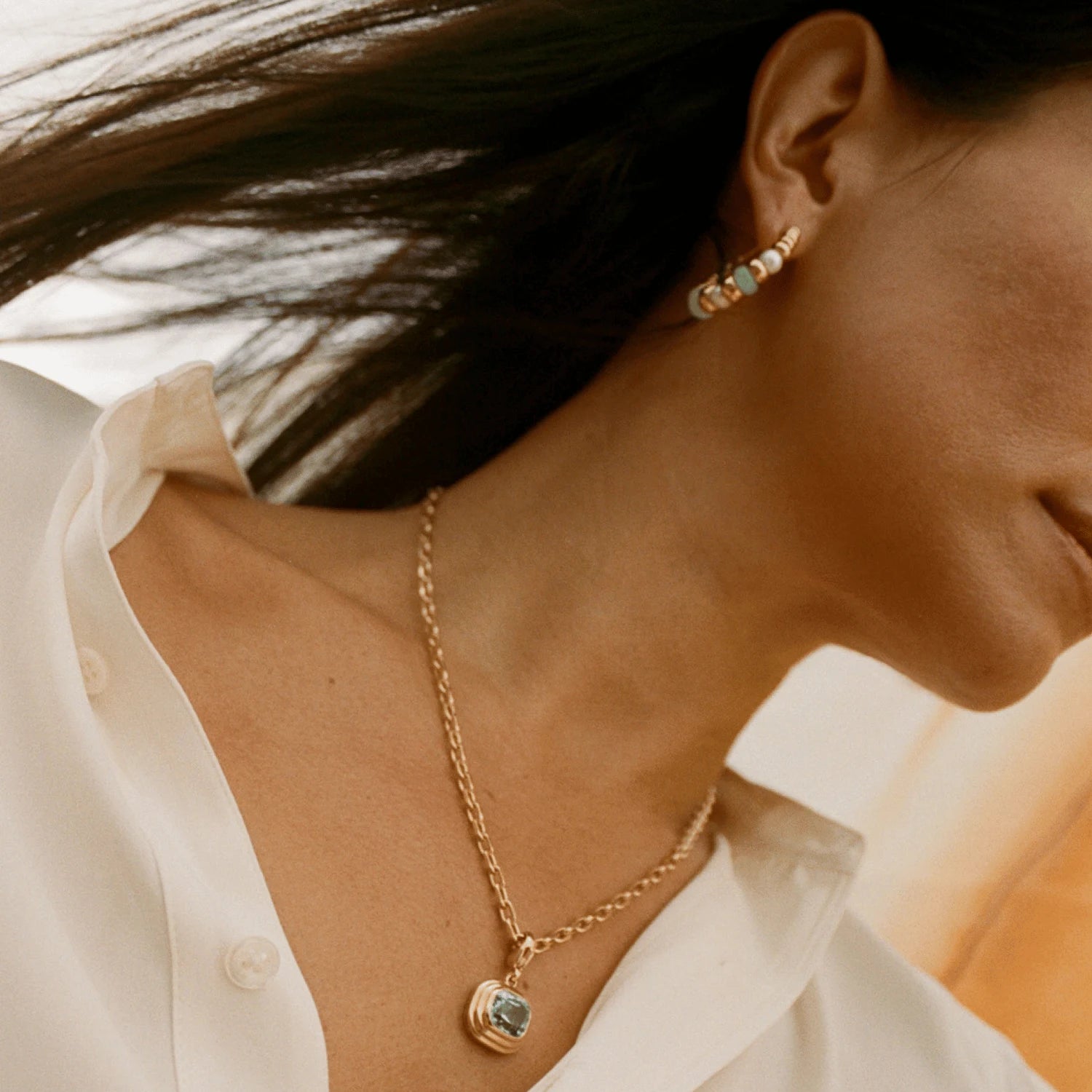 Close-up of Atlantis chrysoprase and pearl hoop earrings in 18k yellow gold with green chrysoprase beads and white freshwater pearls