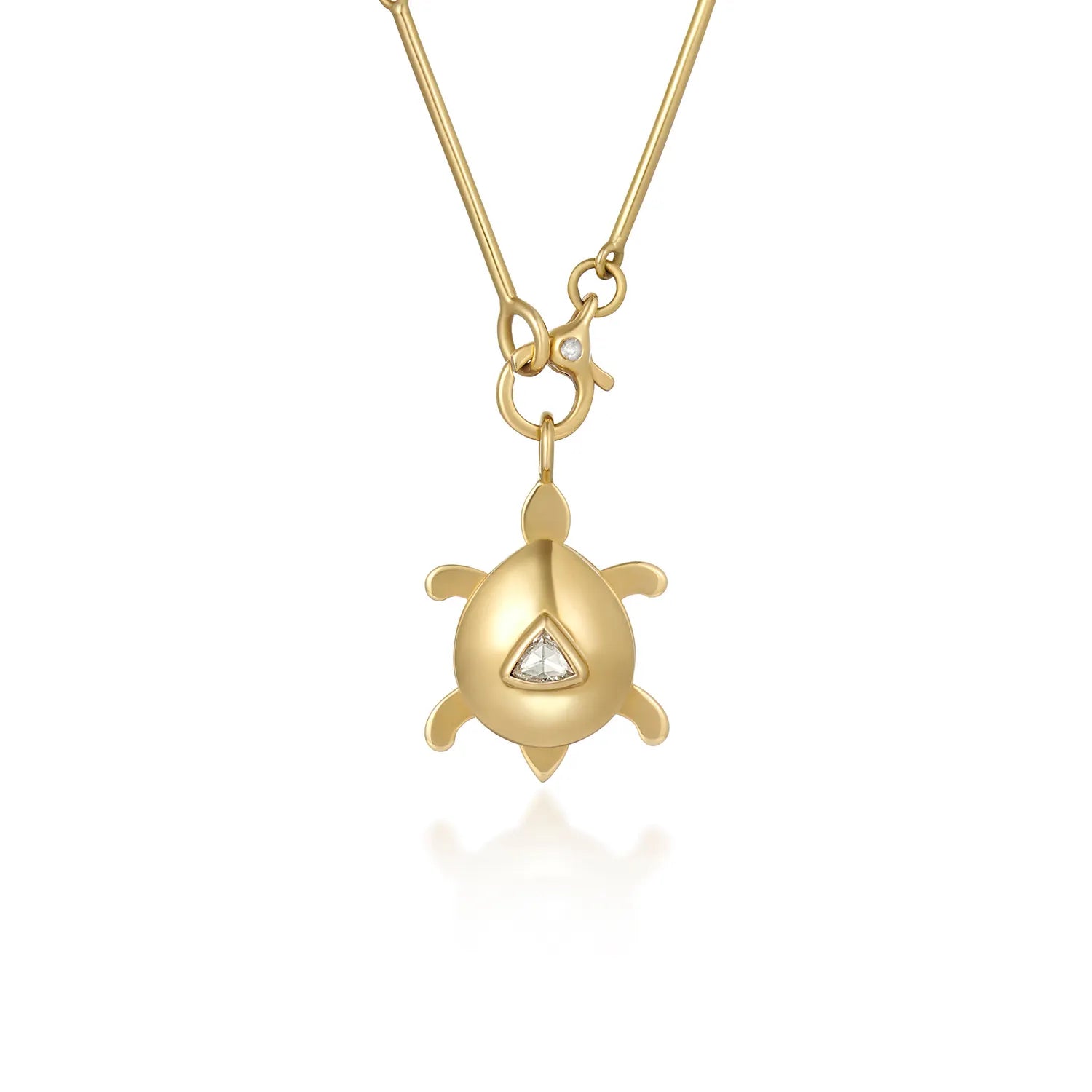 Atlantis dancing turtle diamond charm in solid 18k yellow gold with trillion-cut diamond attached to a necklace chain