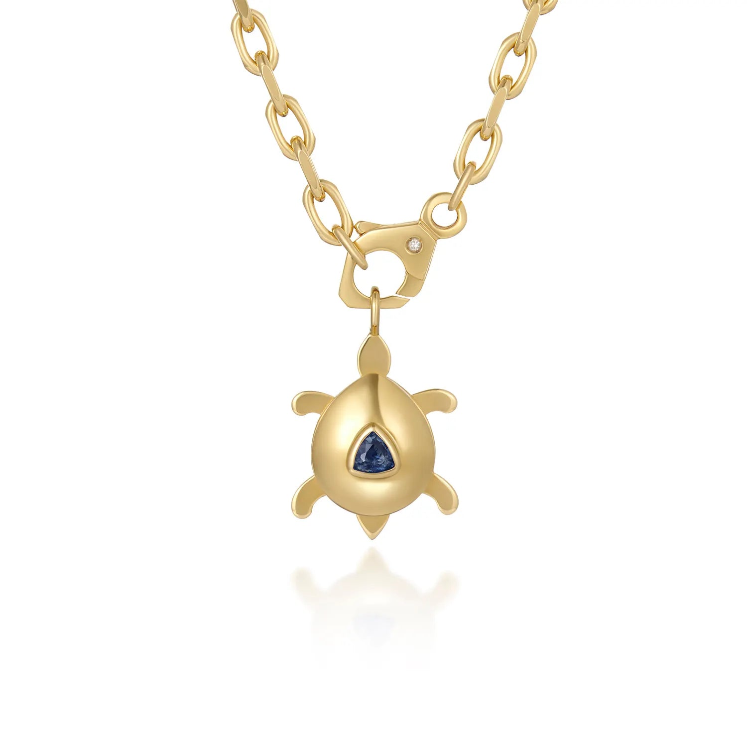 Atlantis dancing turtle sapphire charm in 18k yellow gold with trillion-cut sapphire worn on a cord or gold chain