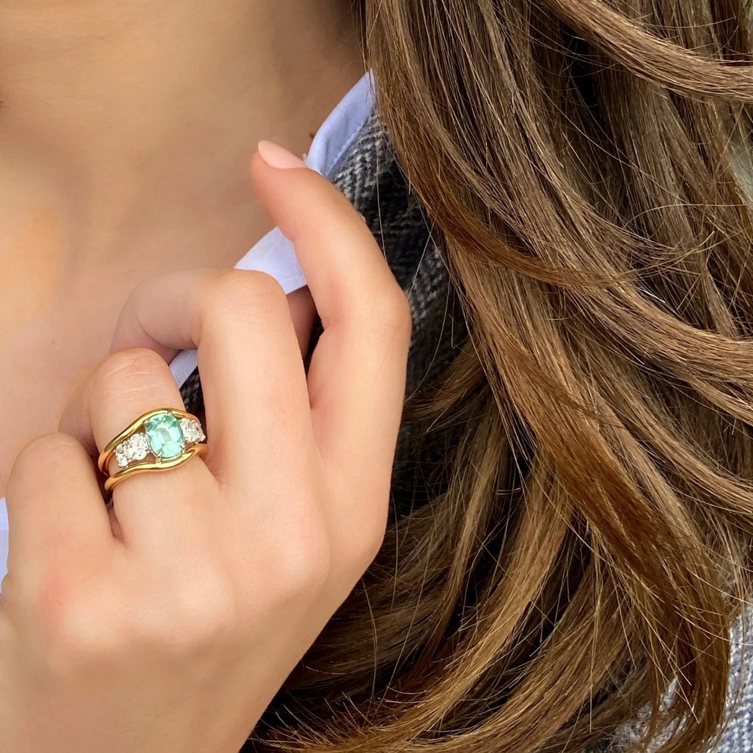 Model wearing Atlantis green tourmaline and diamond ring in 18k yellow gold with mermaid-inspired design