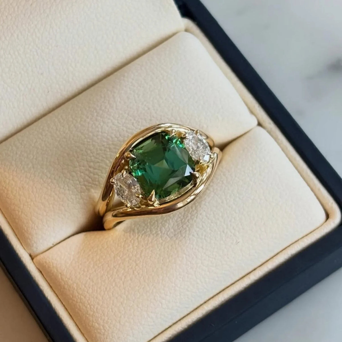 Close-up of Atlantis green tourmaline mermaid ring in 18k yellow gold with square cushion-cut tourmaline and round white diamonds
