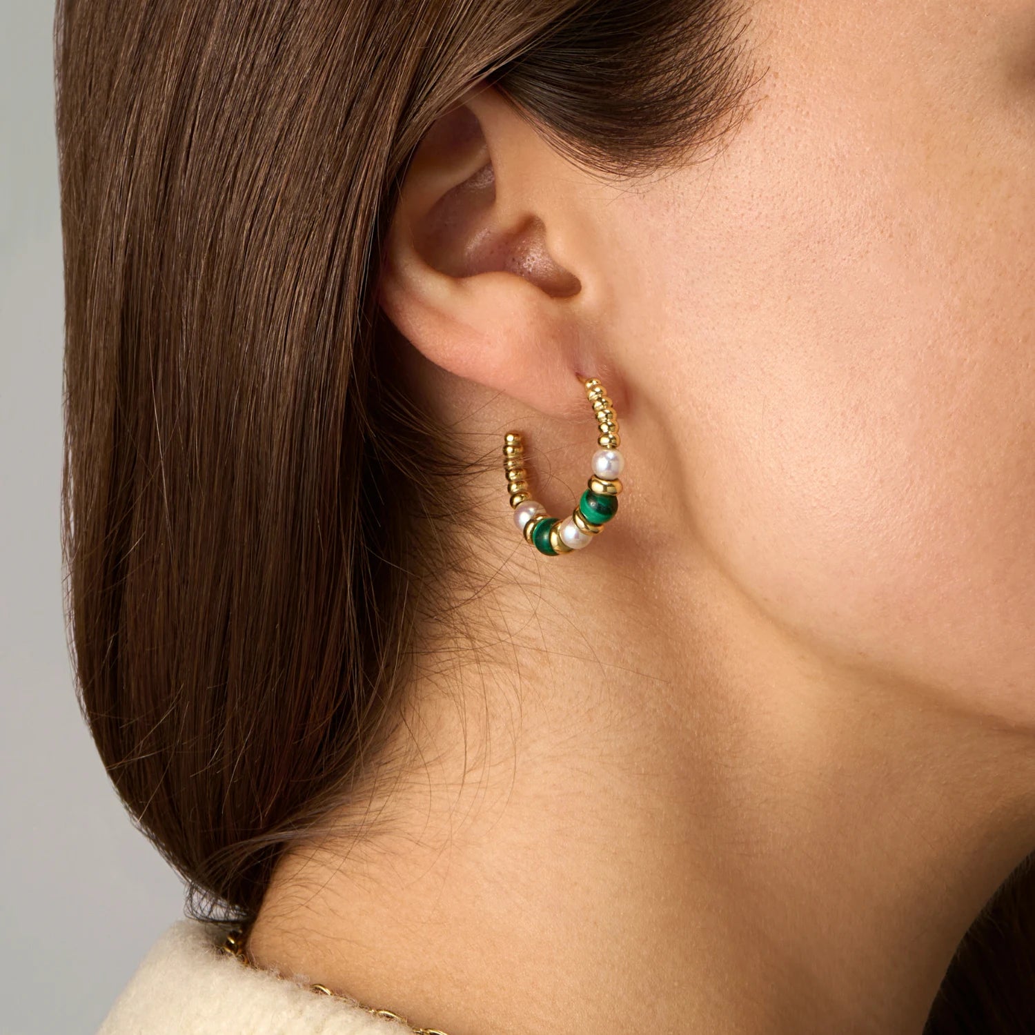 Close-up of Atlantis Malachite and Pearl Hoop Earrings in 18k yellow gold with green malachite beads and white freshwater pearls