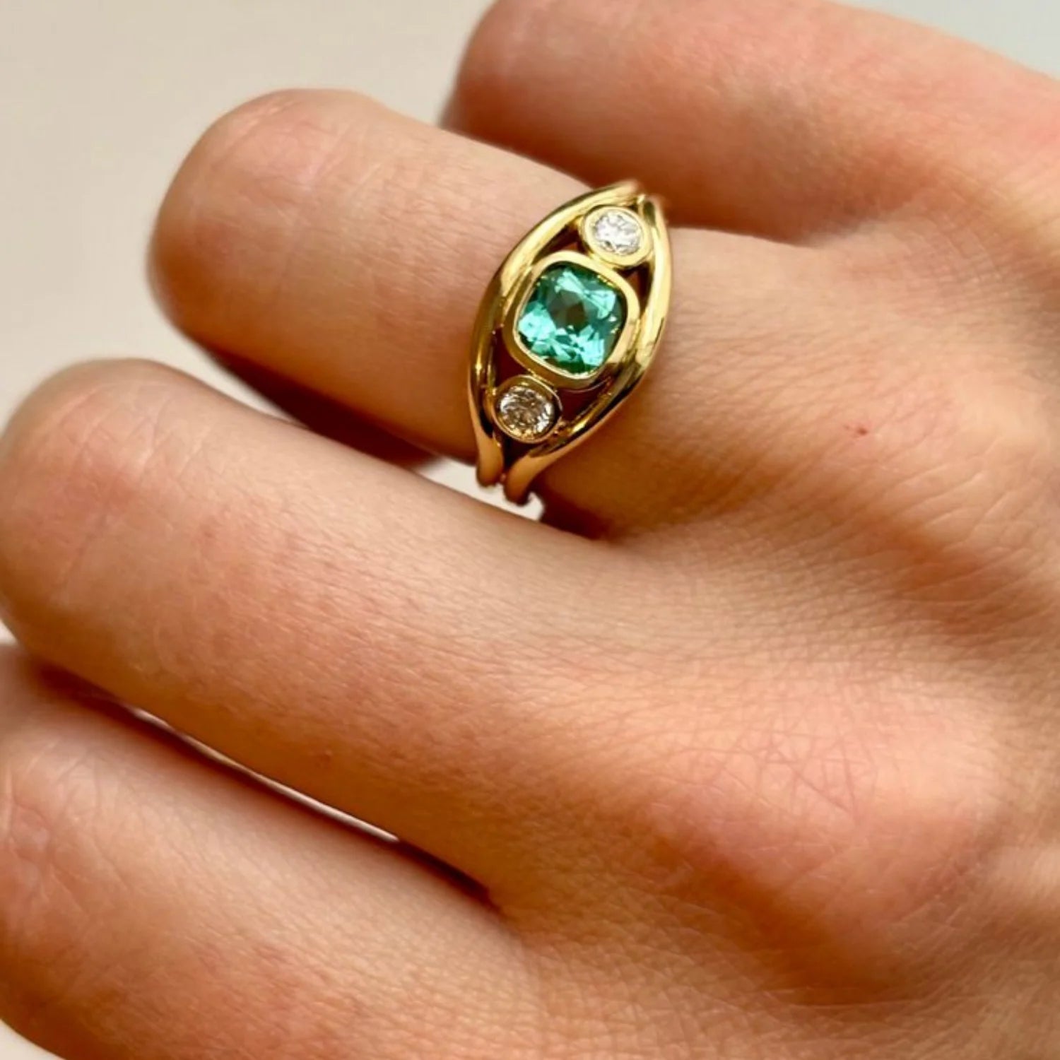 Close-up of Atlantis Small Ocean Blue Tourmaline Mermaid Ring in 18k yellow gold with 0.87ct square cushion-cut ocean blue tourmaline and 0.20ct round white diamonds