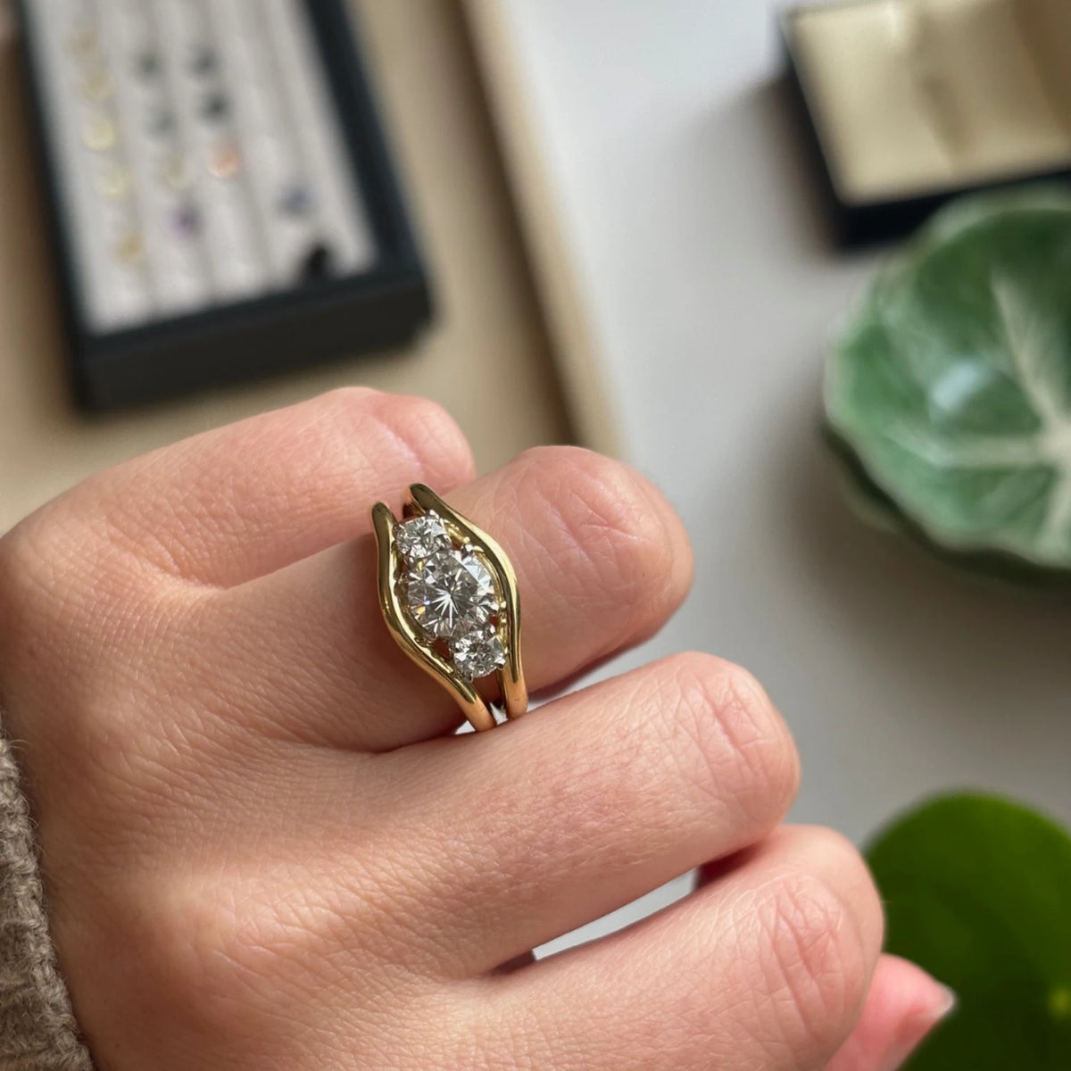 Close-up of Atlantis in 18k yellow gold mermaid band with trio round white diamonds