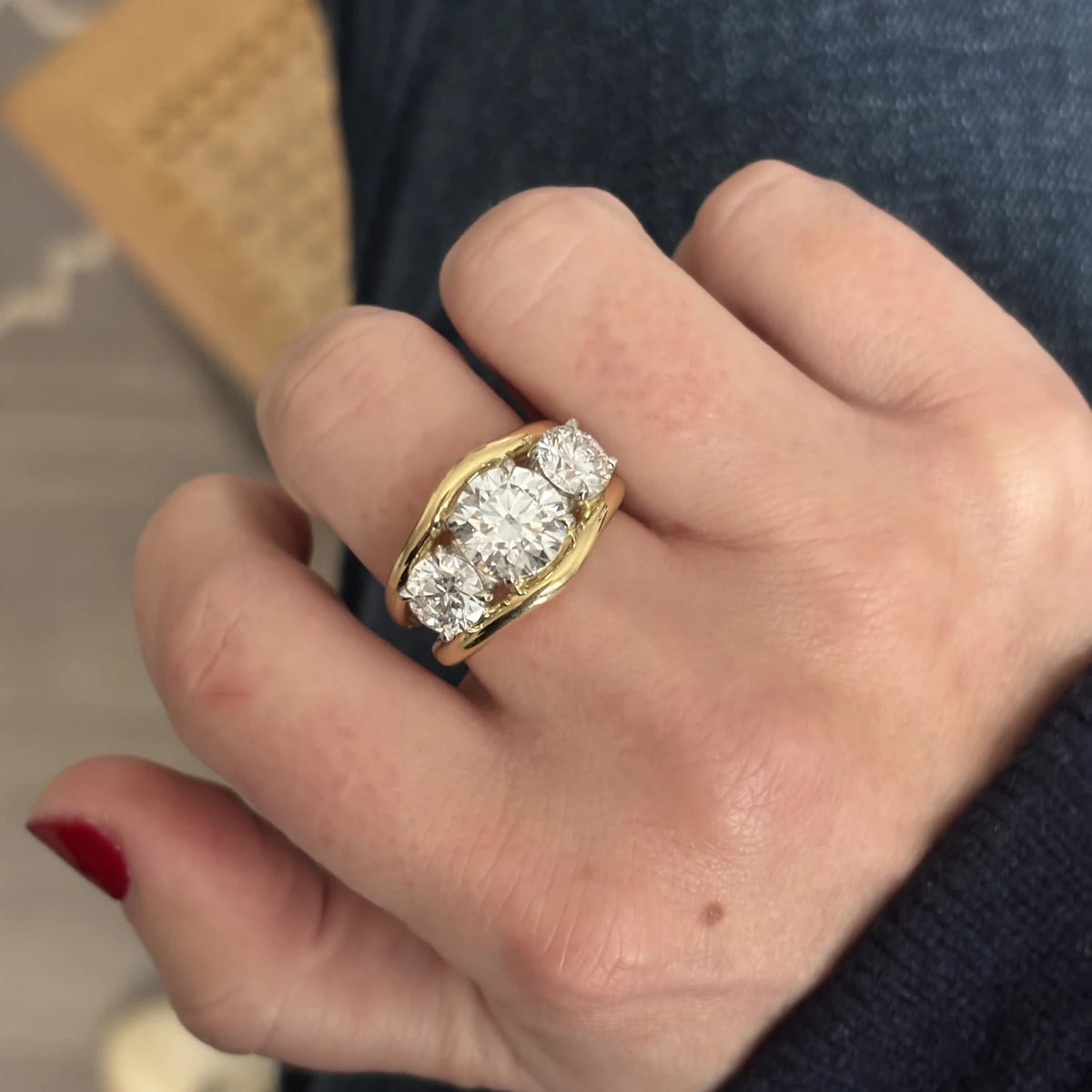 Close-up of Atlantis in 18k yellow gold mermaid band with trio round white diamonds