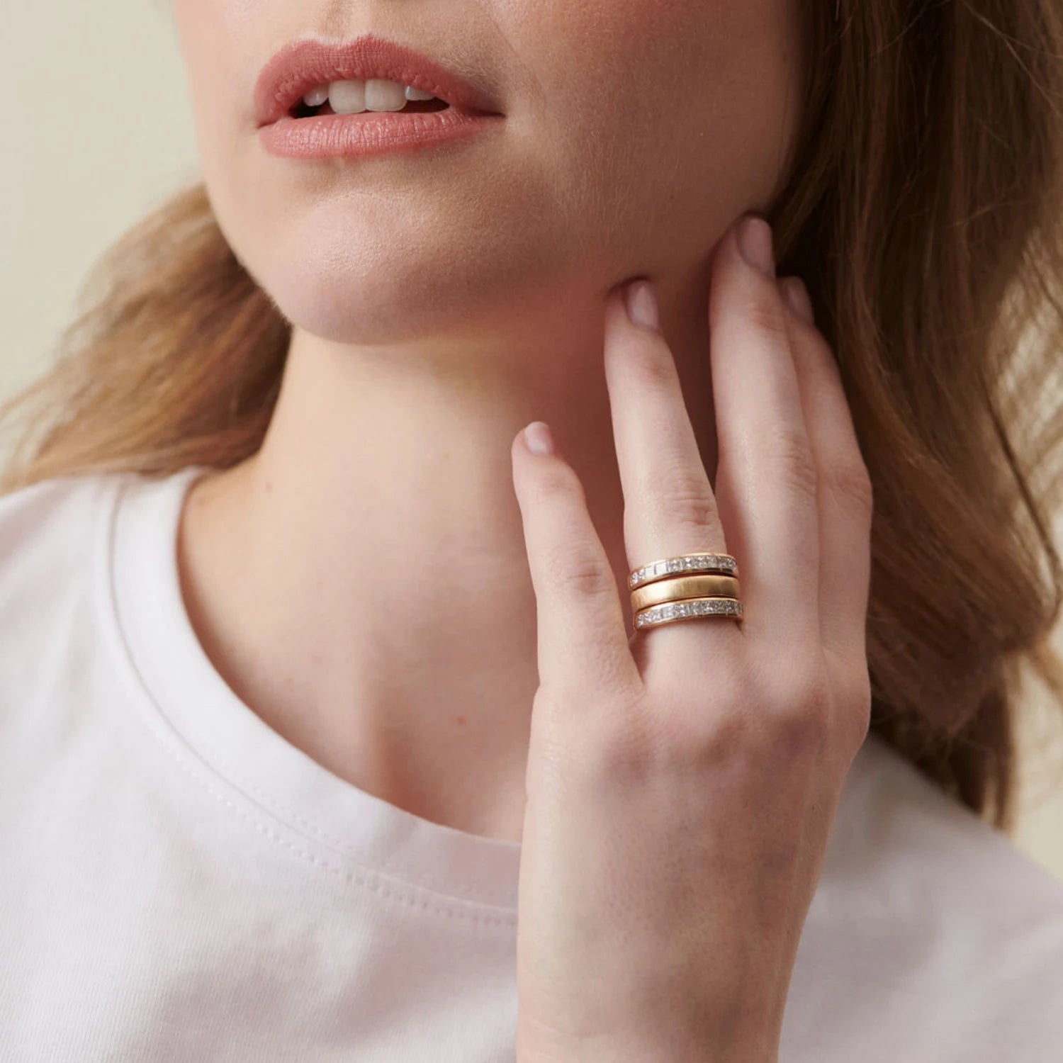 Model wearing Ley Lines Avebury Diamond hinge ring in brushed 18k yellow and white gold with twelve square-cut diamonds totaling 1.80ct